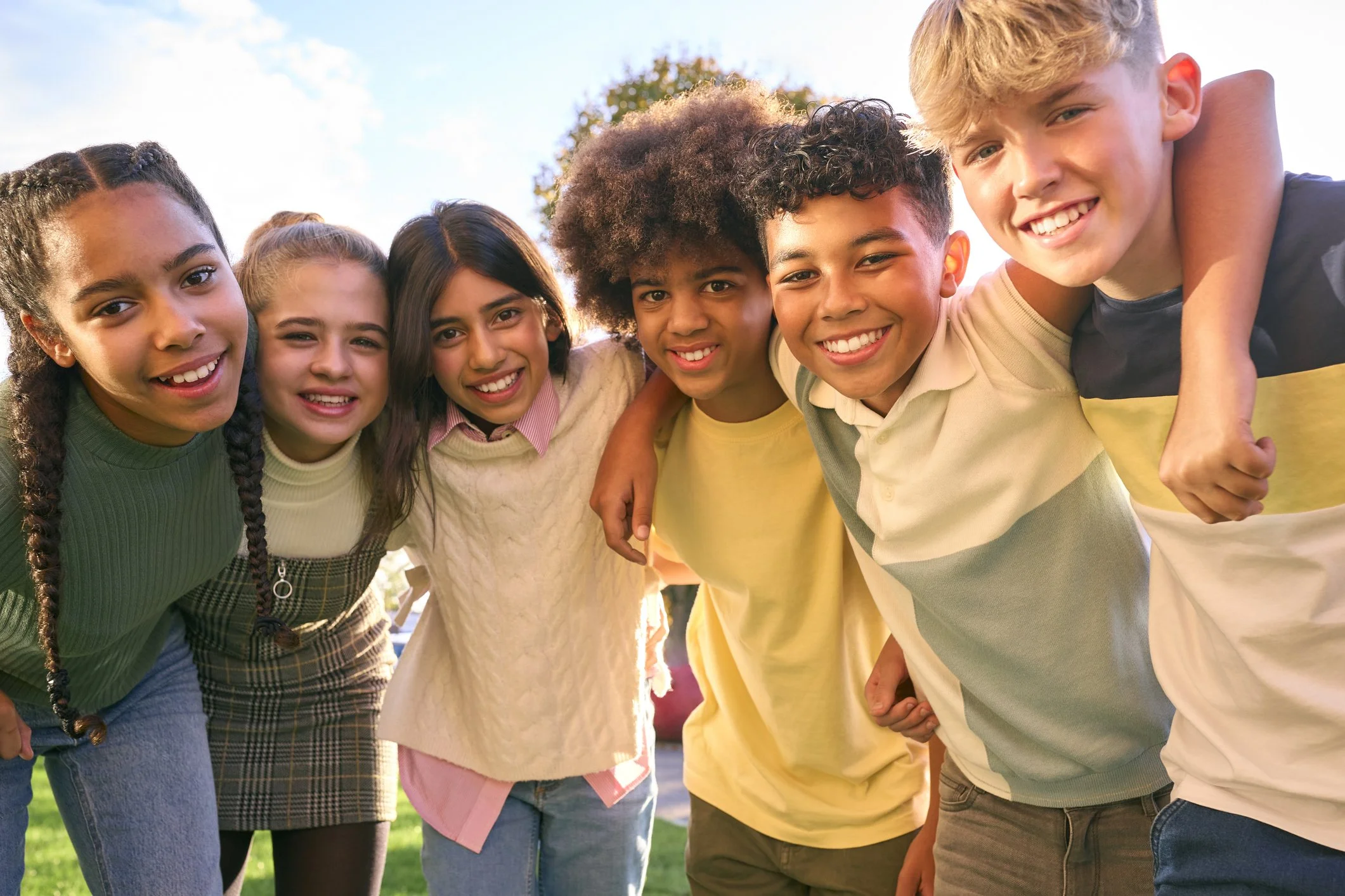 Children smiling and talking together during speech therapy services in South Jersey.