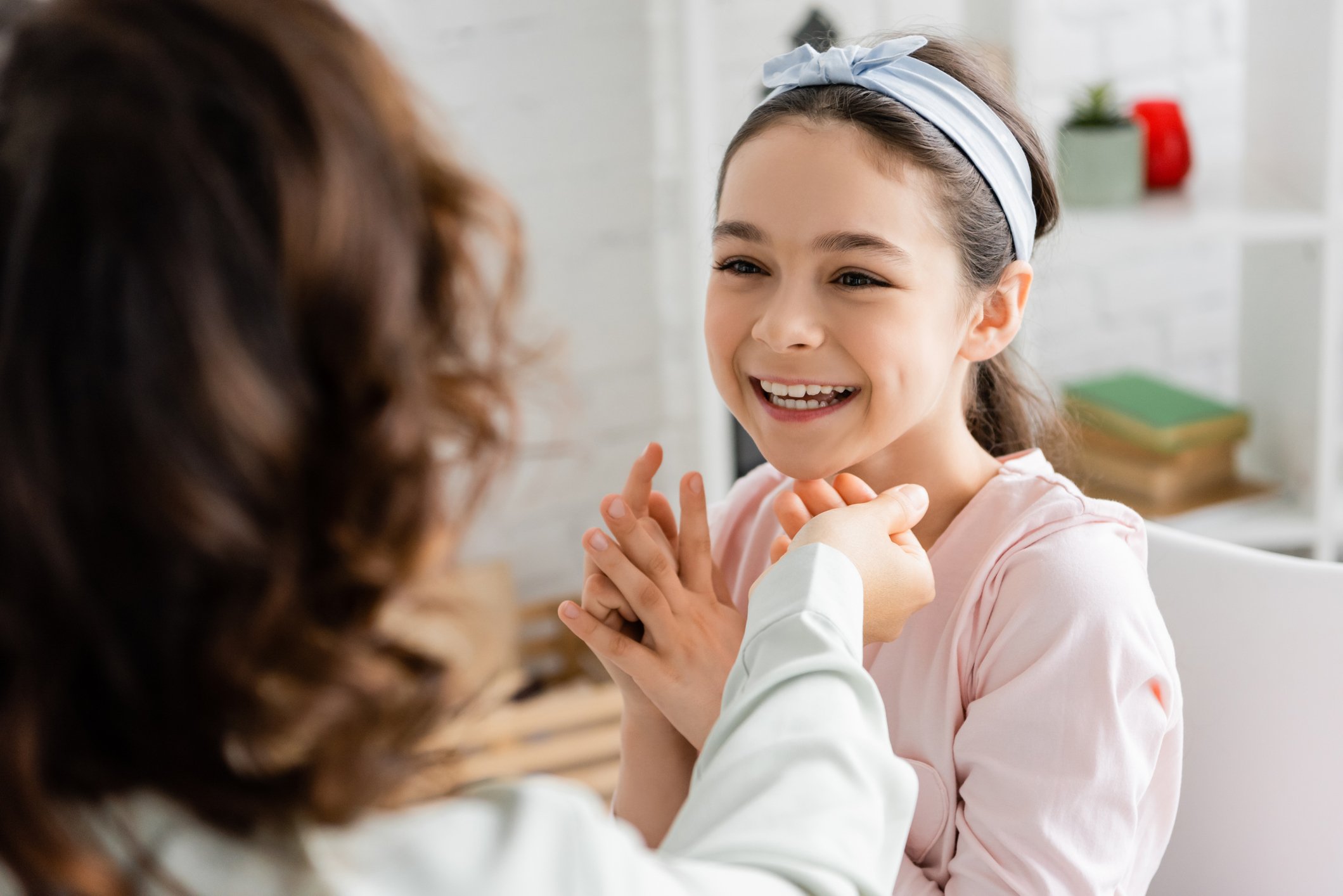 Child practicing speech sounds with a speech-language pathologist during a reading and speech therapy session in Haddonfield, NJ