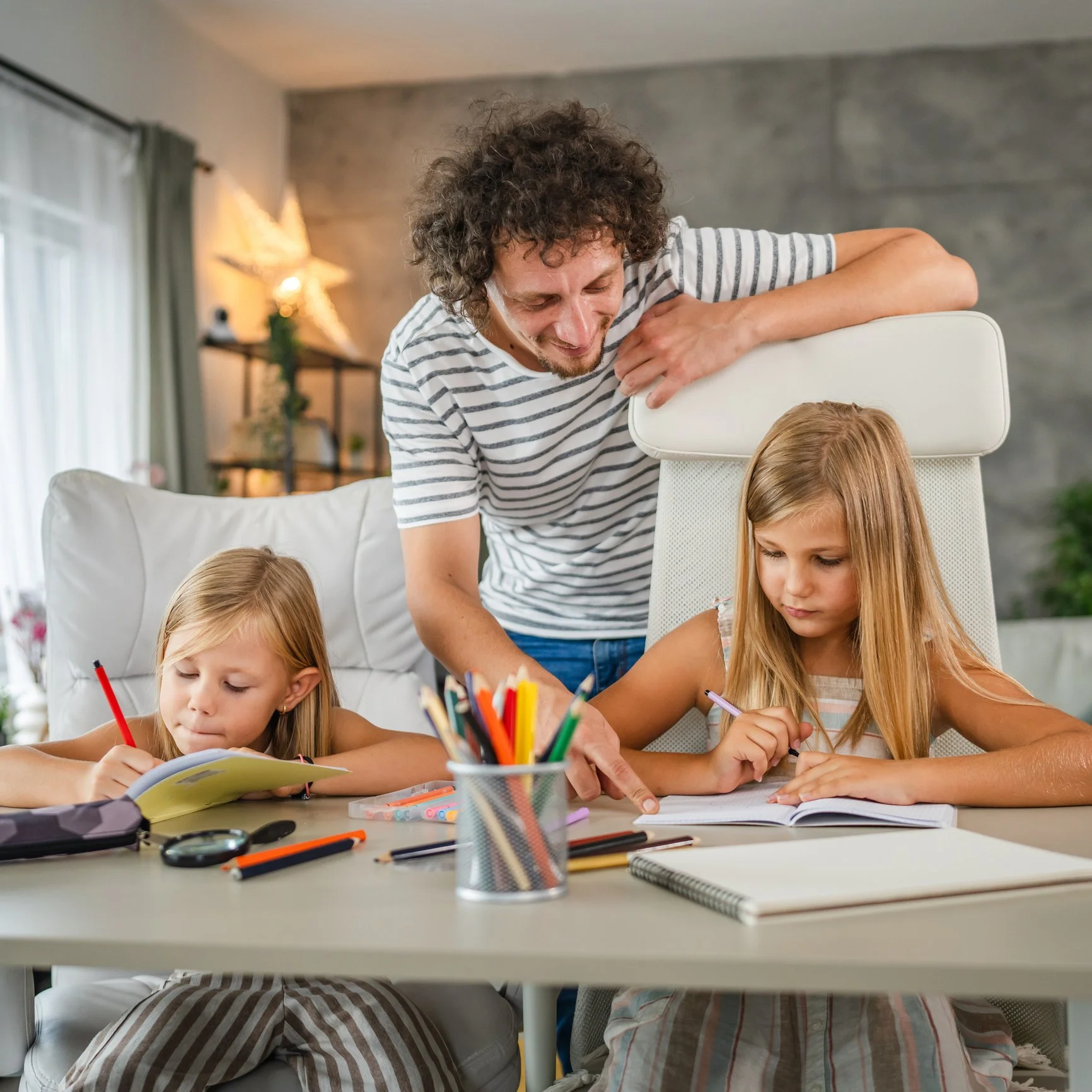 Parent helping a child with reading, writing, and language skills during home practice