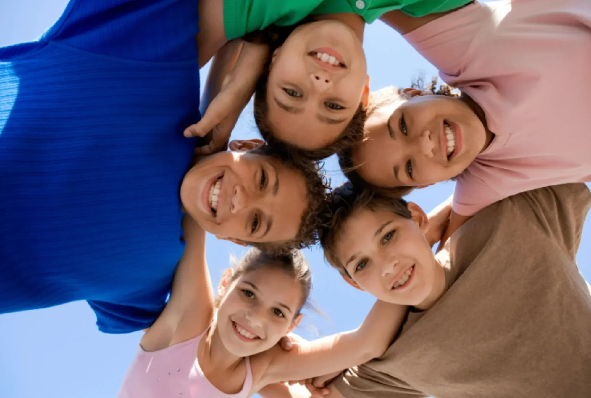 Kids smiling and building confidence during speech therapy and reading support focused on communication and literacy skills