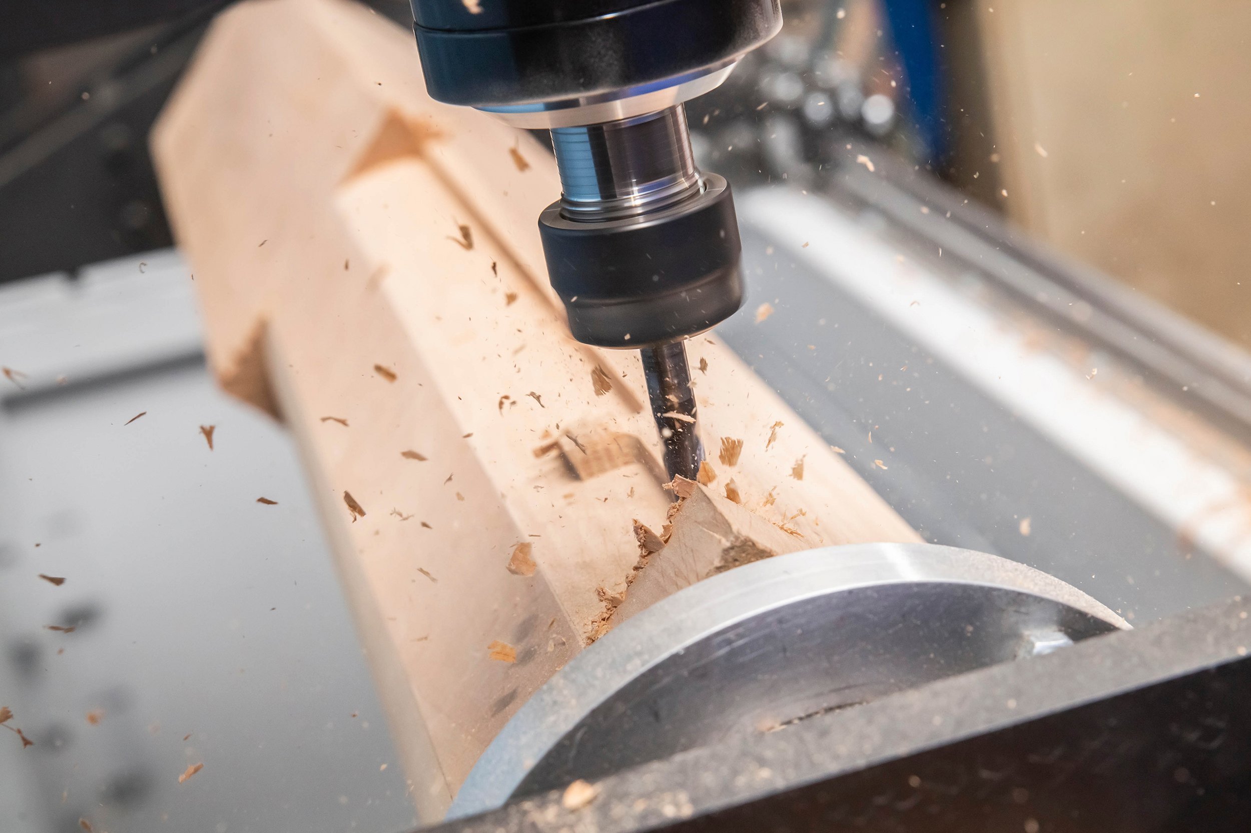 CNC machine processes wood blank at high speed