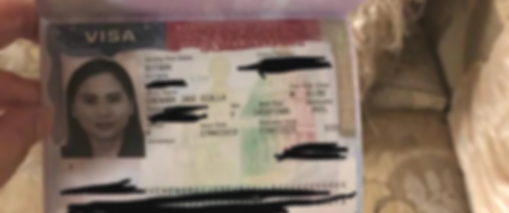 A blurry image of a person's identification card, likely a visa or similar document, with a photo of a woman, various text, and security features.