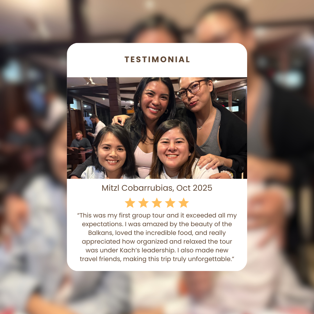 Group photo of four women smiling in a restaurant, with some behind and some in front, during a trip. A caption highlights a trip to the Balkans with a five-star review and testimonial about their experience.