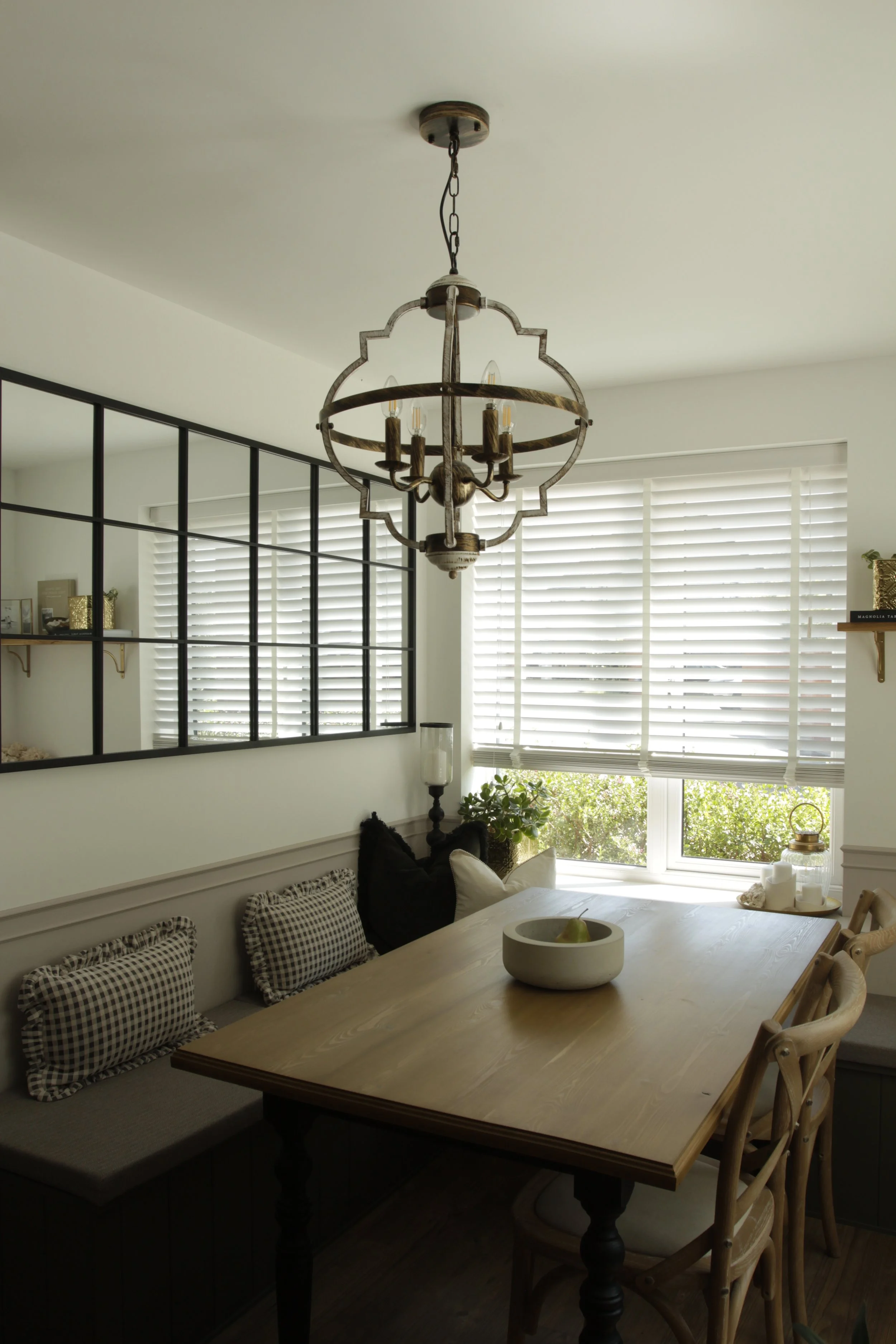 French bistro inspired dining nook featuring bespoke built-in L-shaped banquette seating, integrated storage and a solid oak dining table.