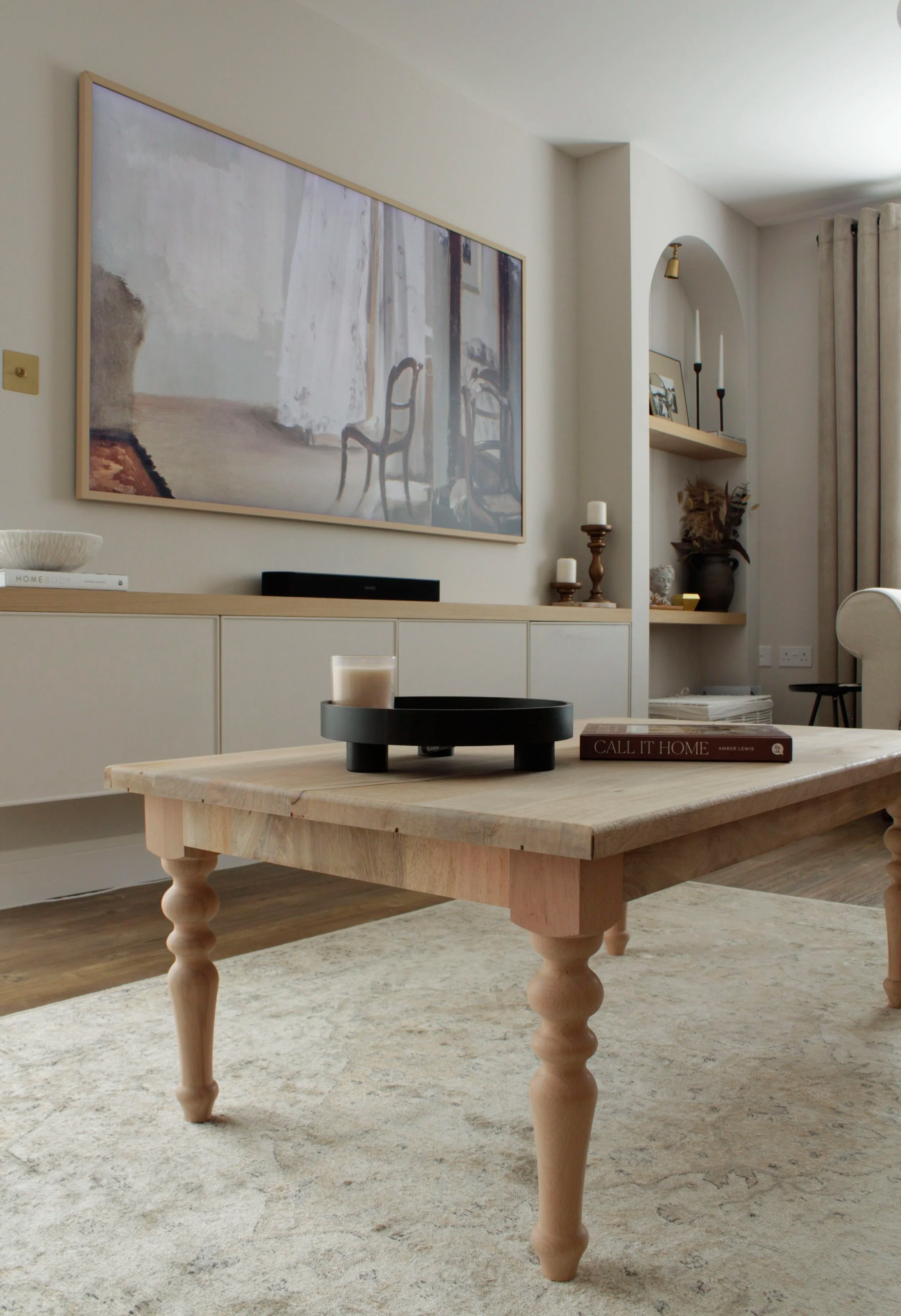 Bespoke media wall with arched shelving, oak details and integrated storage in a modern farmhouse living room.