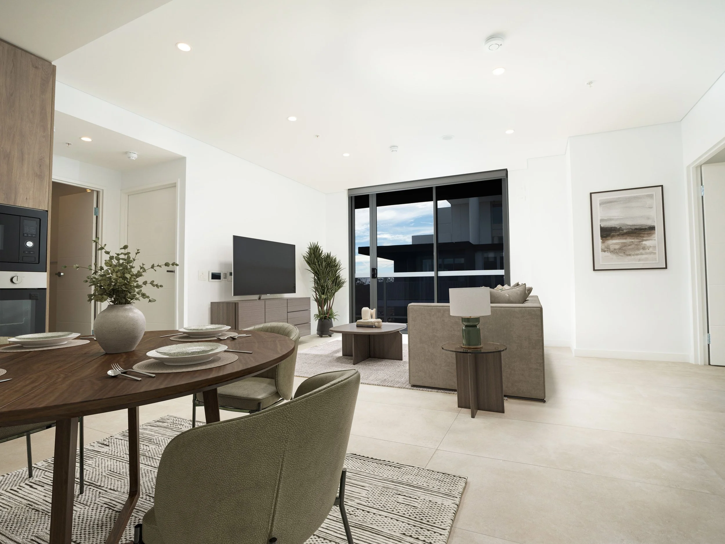 Dining table and living room with big sofa and tv