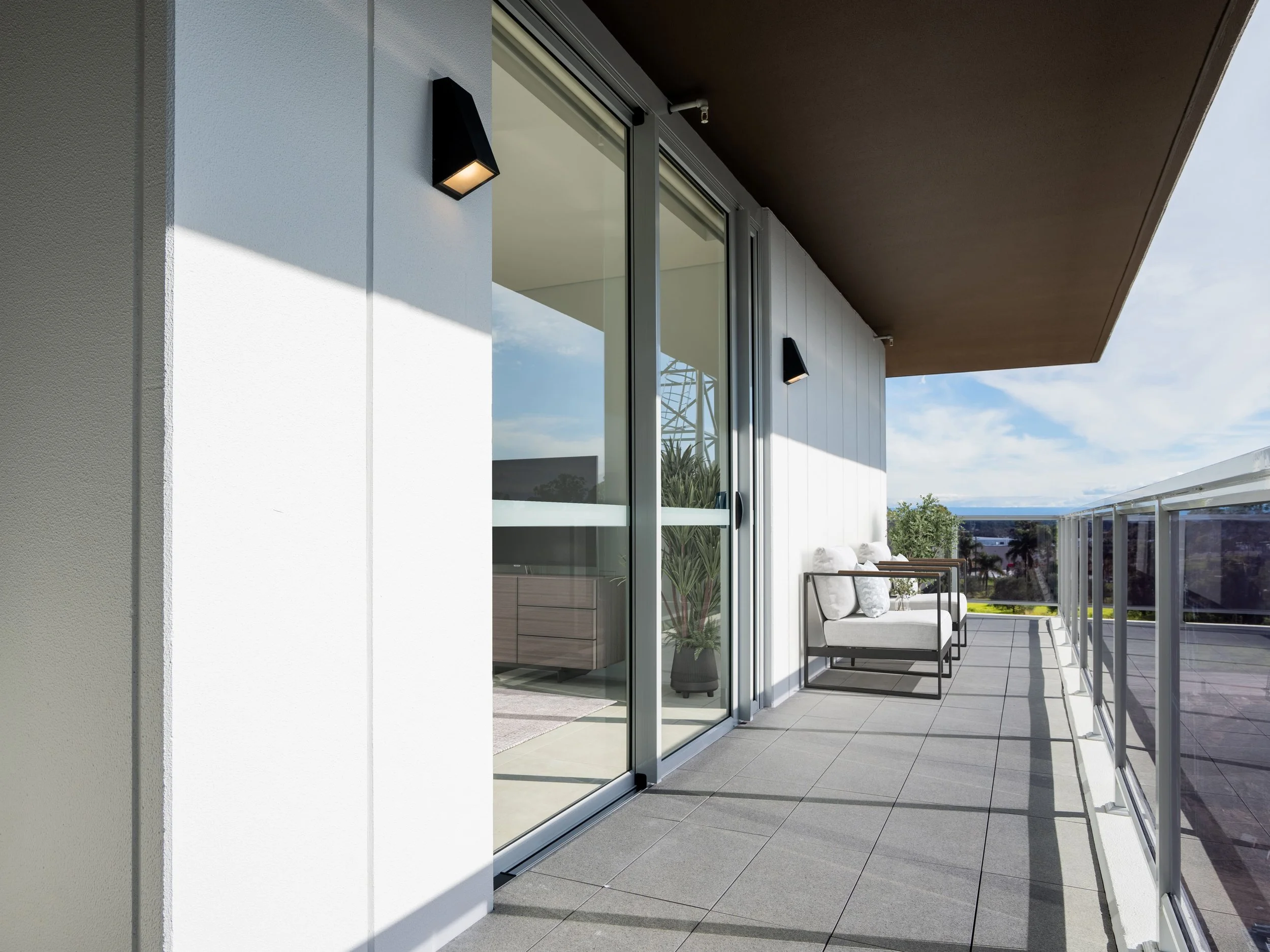 Big balcony with seating chairs and small table