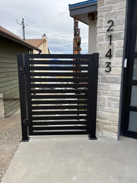 contemporary privacy gate attached to home