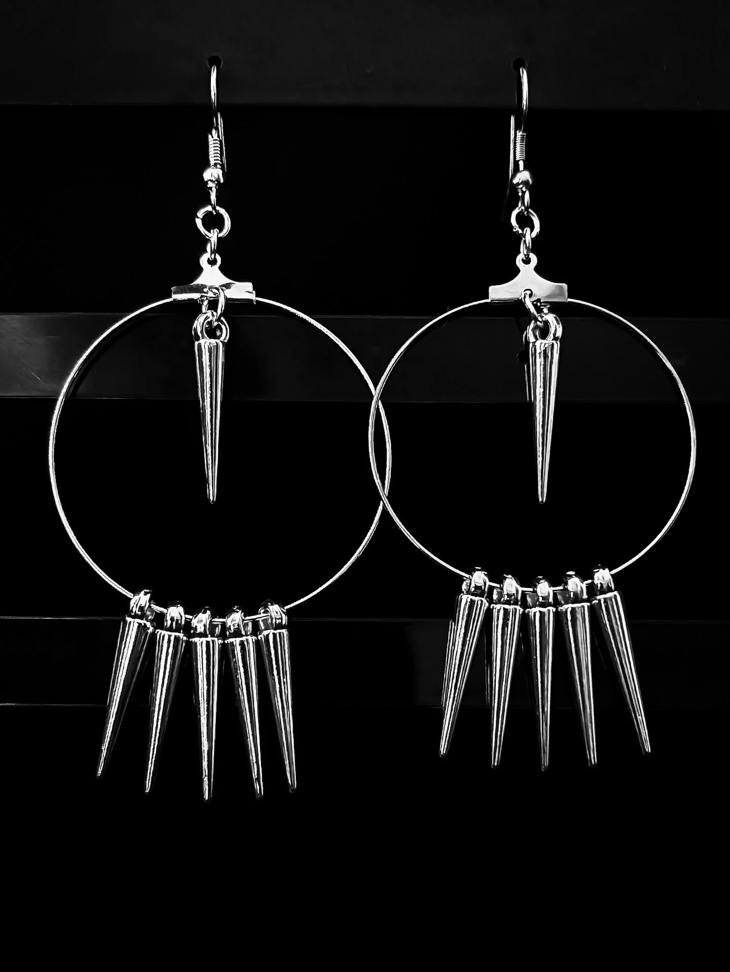 Light on the ear, heavy on intent. Spiked Reverie twists between minimal form and quiet defiance &ndash; silver spikes catching every flicker of light.

Releasing Thursday.

⸻

#nightboundcreations #darkstyle #handmadeaccessories #heavymetalstyle #go