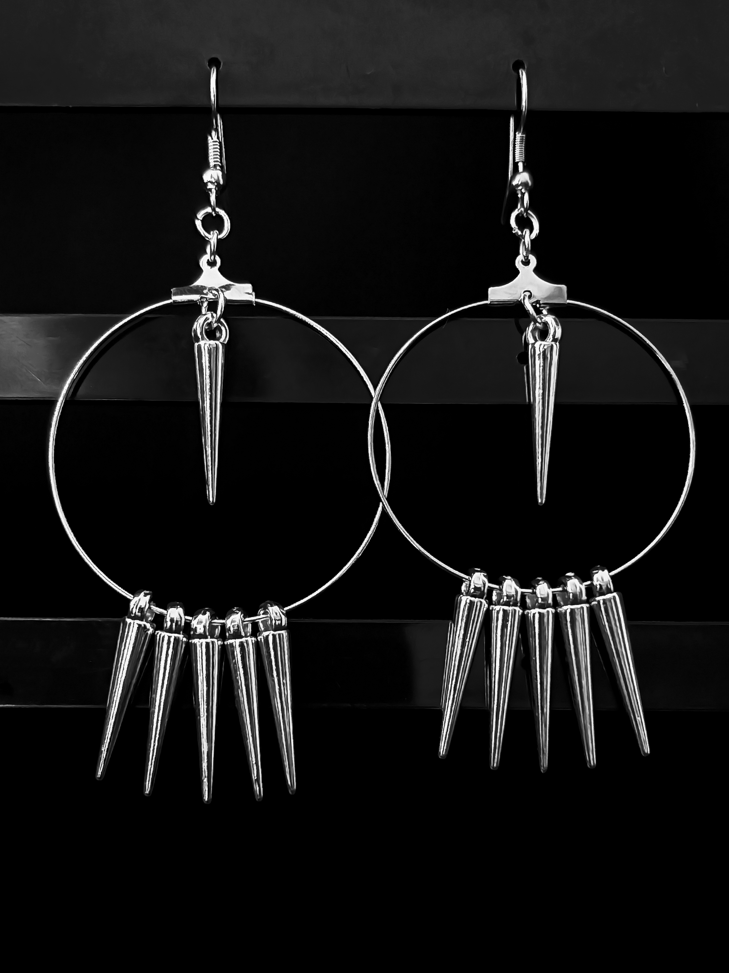 Detailed shot of Spiked Reverie 35 mm hoops in silver stainless steel, each spike hand-set along the ring.
