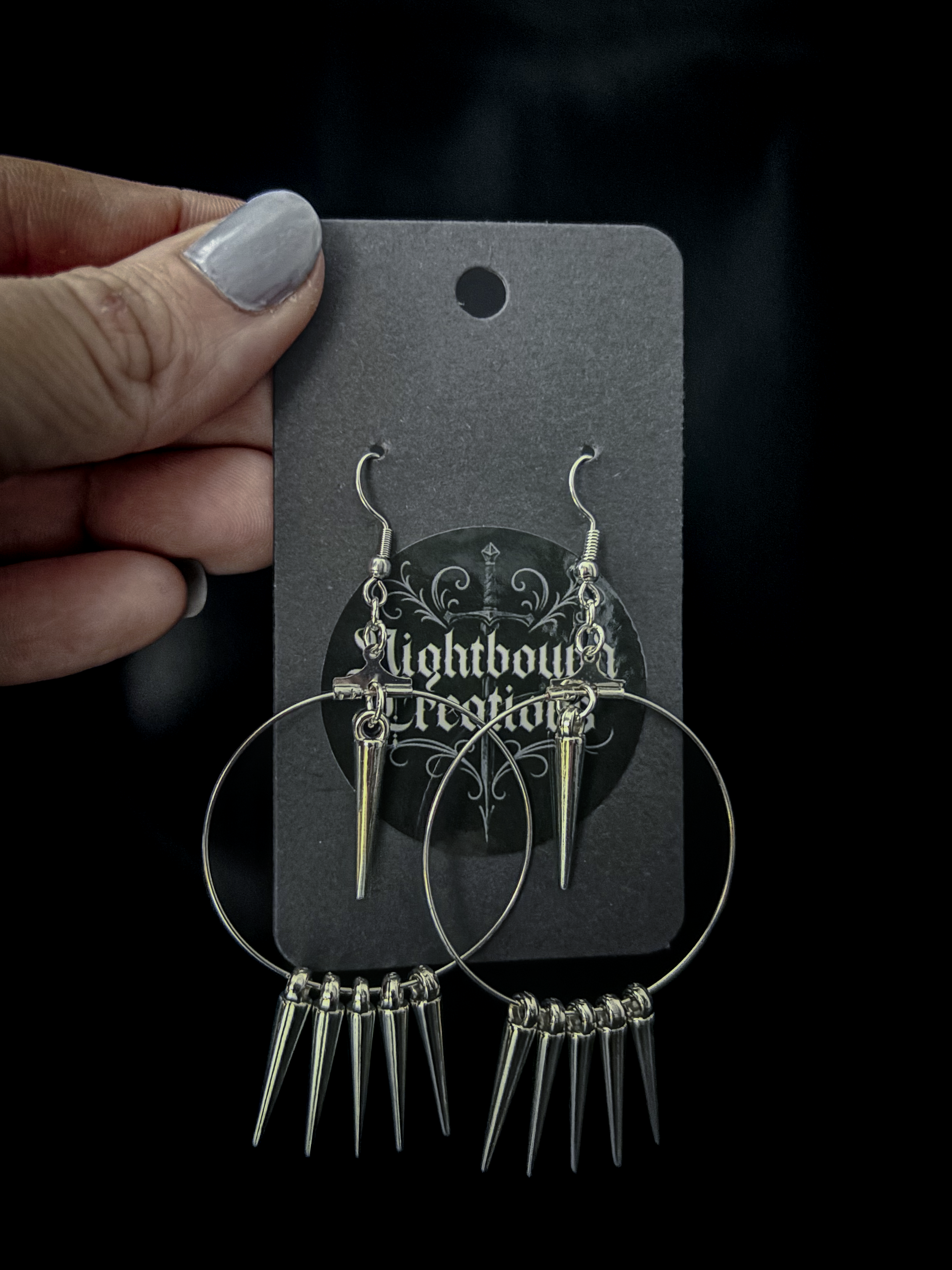 Side view of Spiked Reverie on ear, showing lightweight hoops peeking through dark hair.