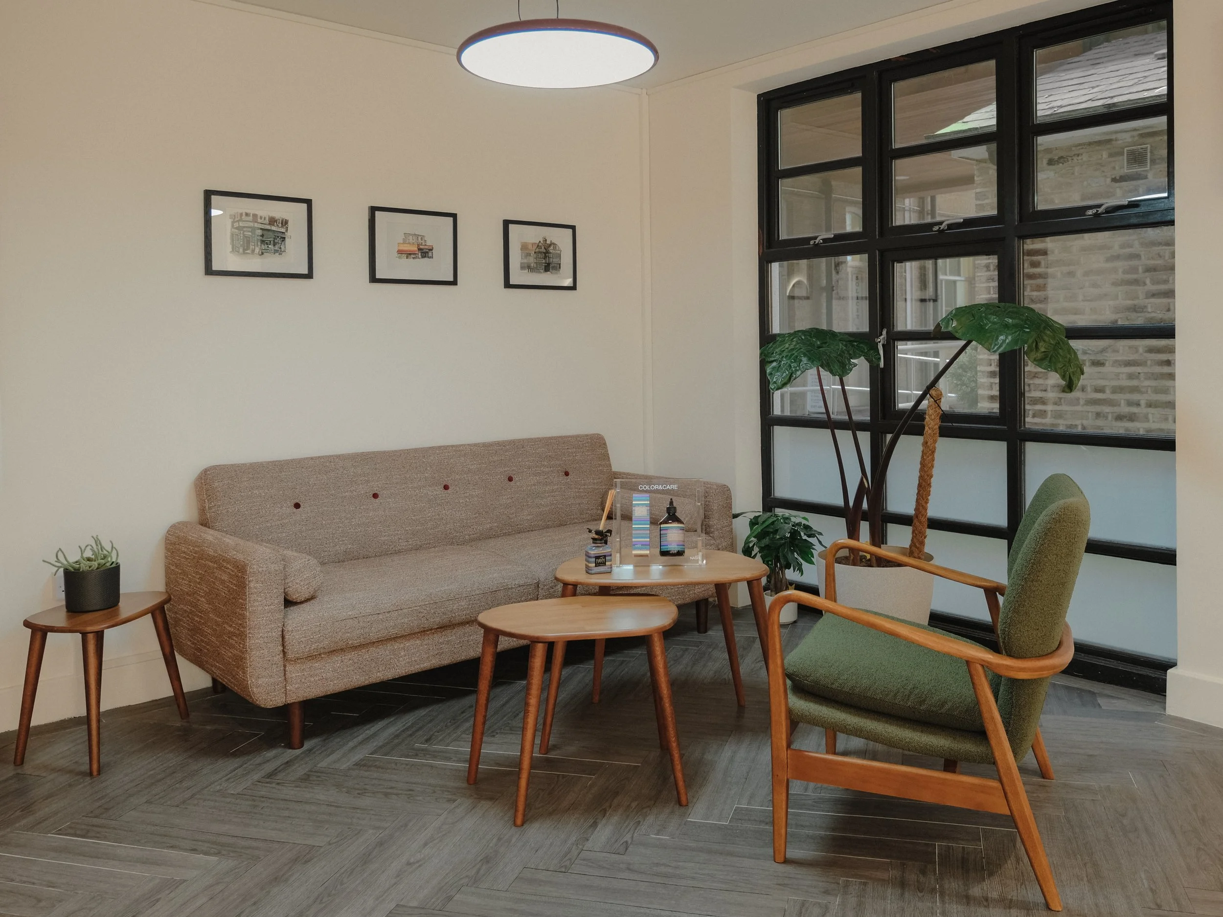 Comfortable seating area inside Alto Hair Studio in Aldgate East.