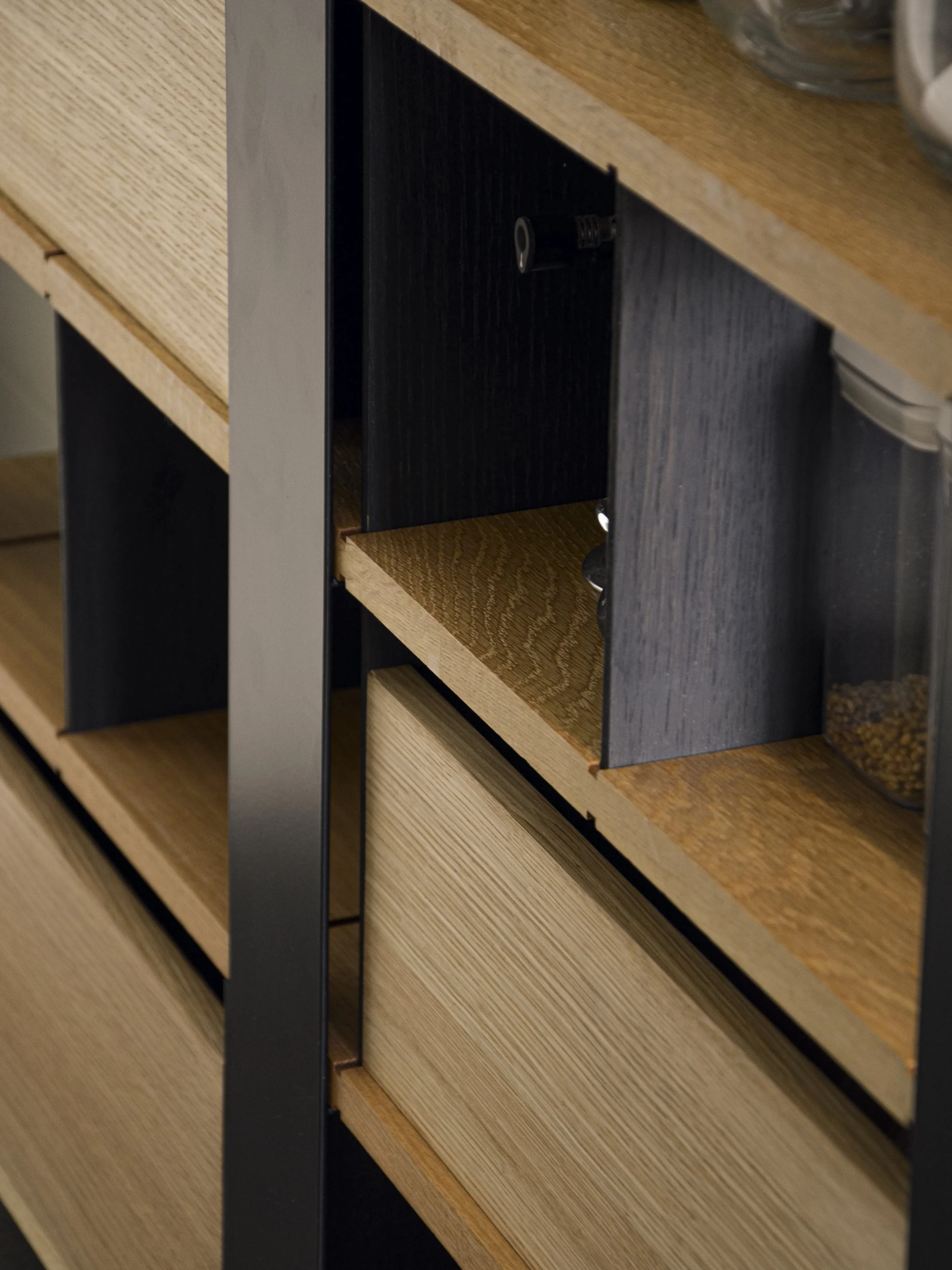 Estante de arrumação com divisórias removíveis, folheada a carvalho americano e elementos em ferro termolacado.