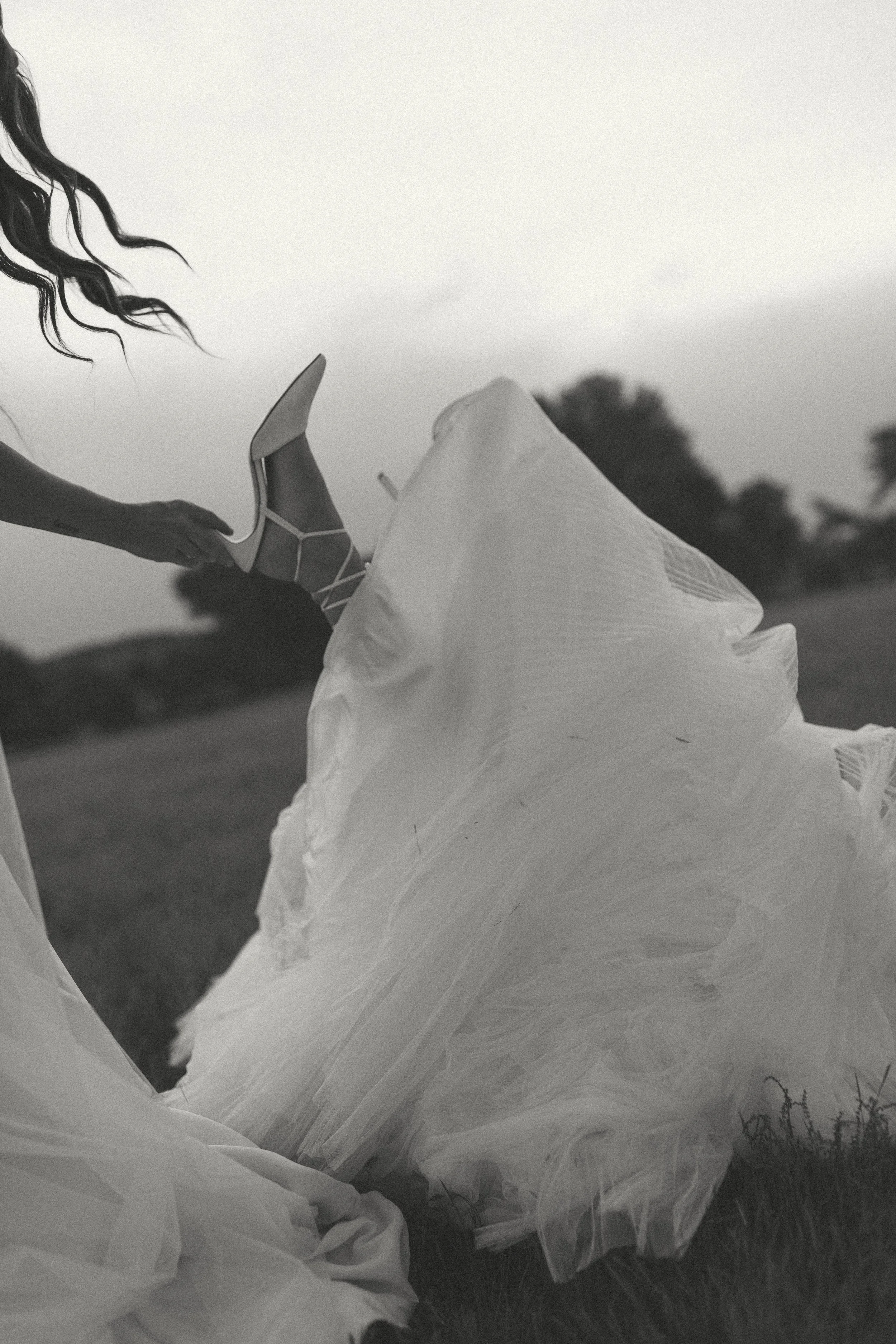 black-and-white-wedding-photo-bride-holding-partners-foot.jpg