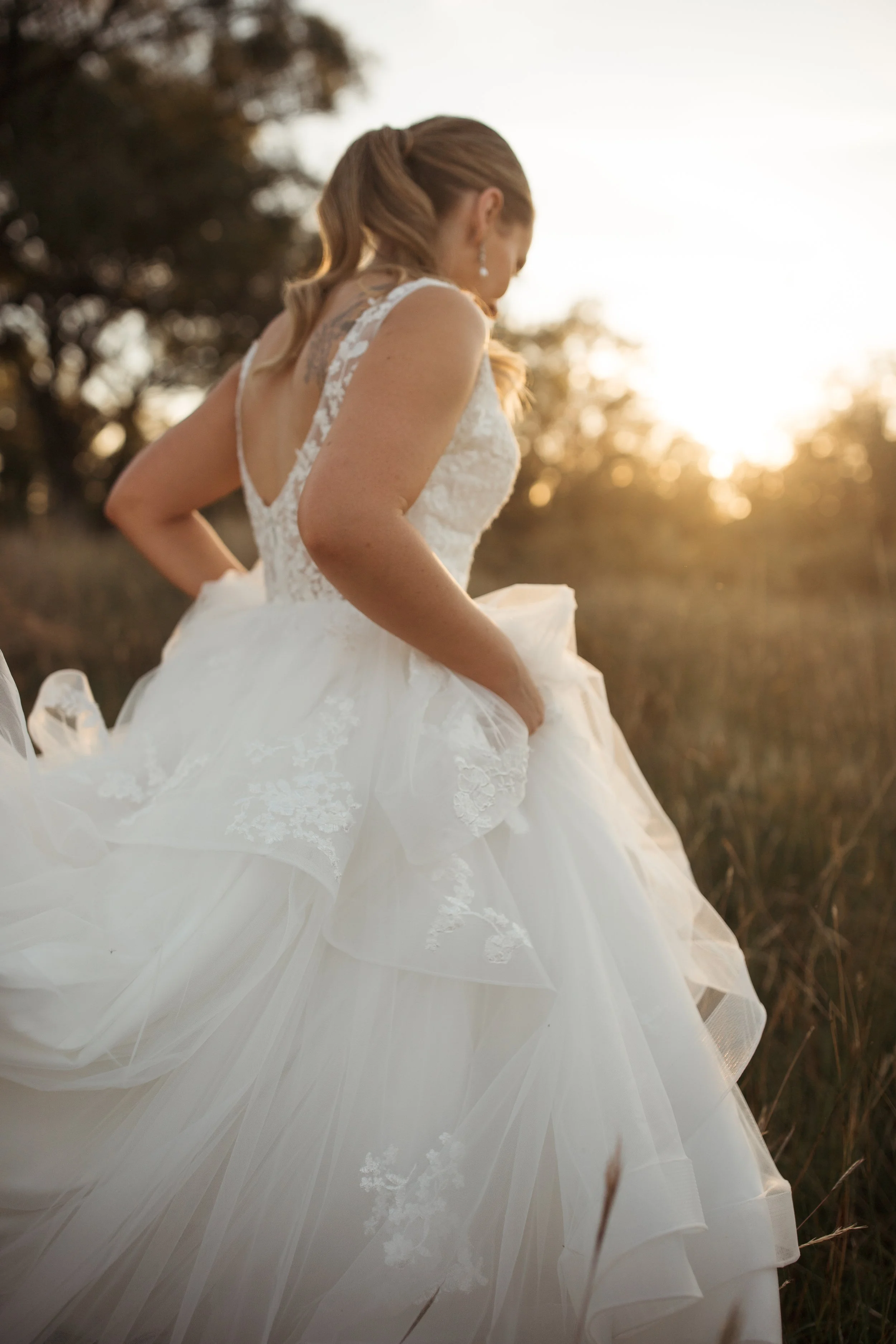 bride-walking-into-sunset-close-up-wedding-dress.jpg