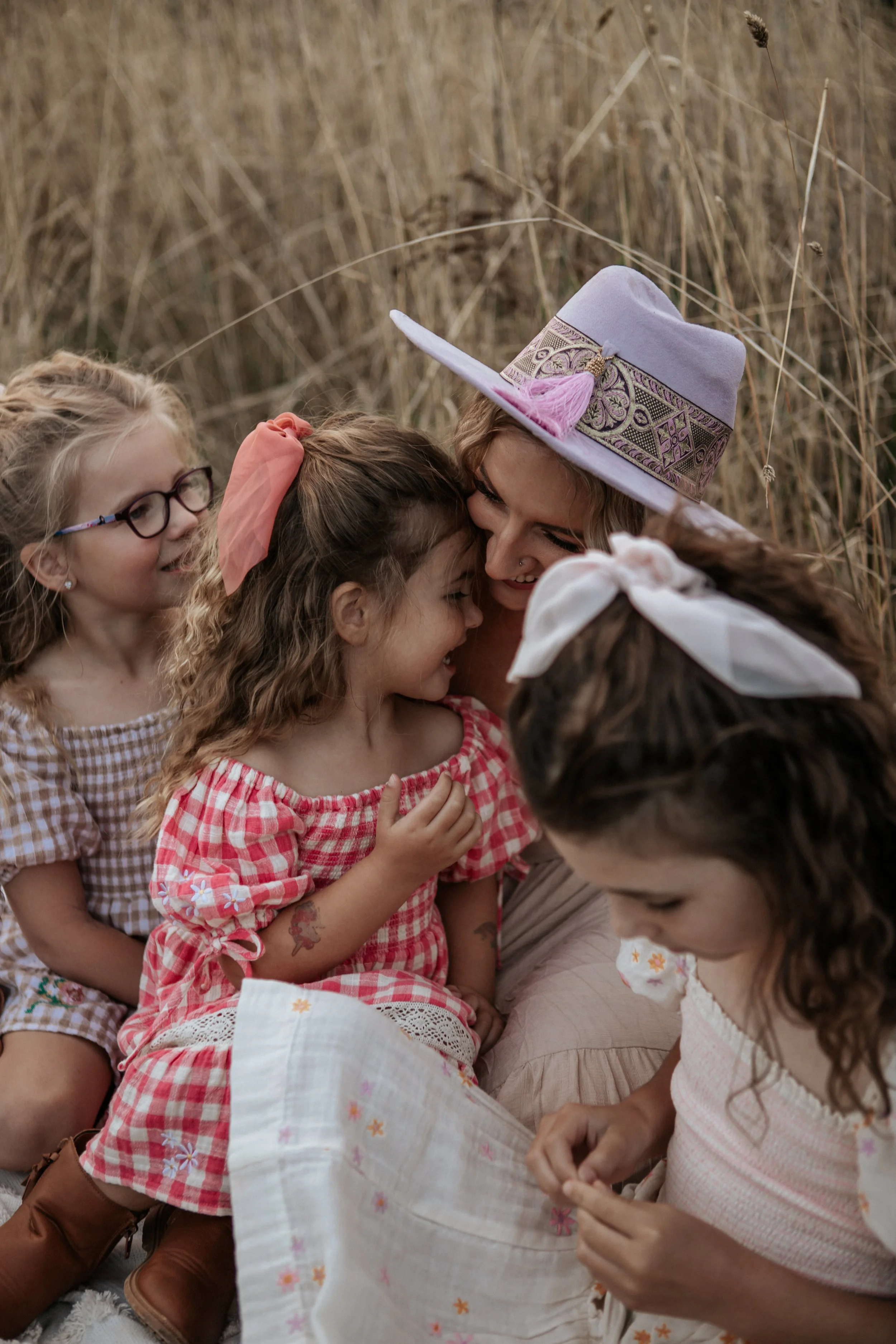 mother-with-three-daughters-sharing-quiet-moment.jpg