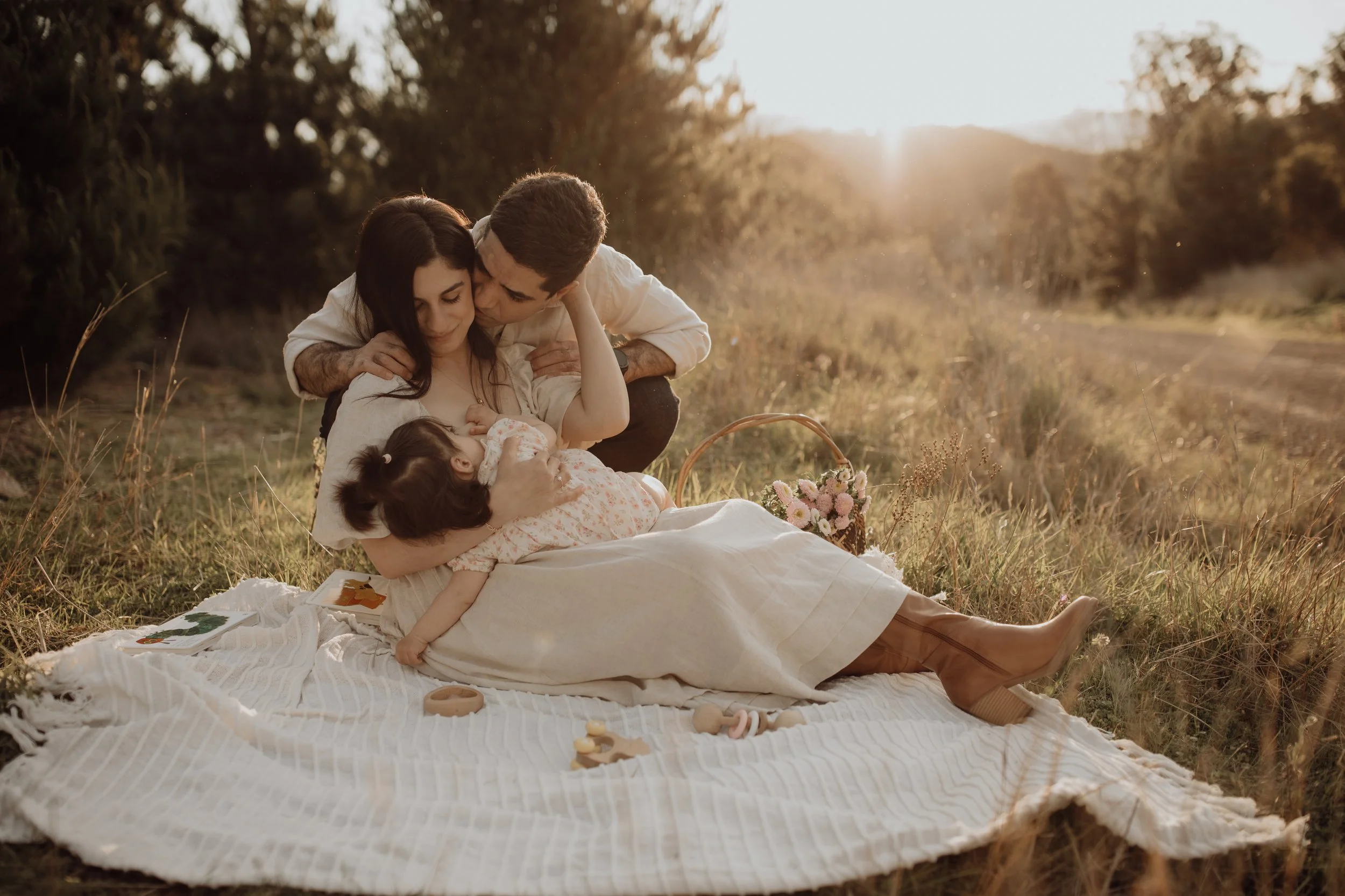 family-photoshoot-breastfeeding-mother-father-sunset.jpg