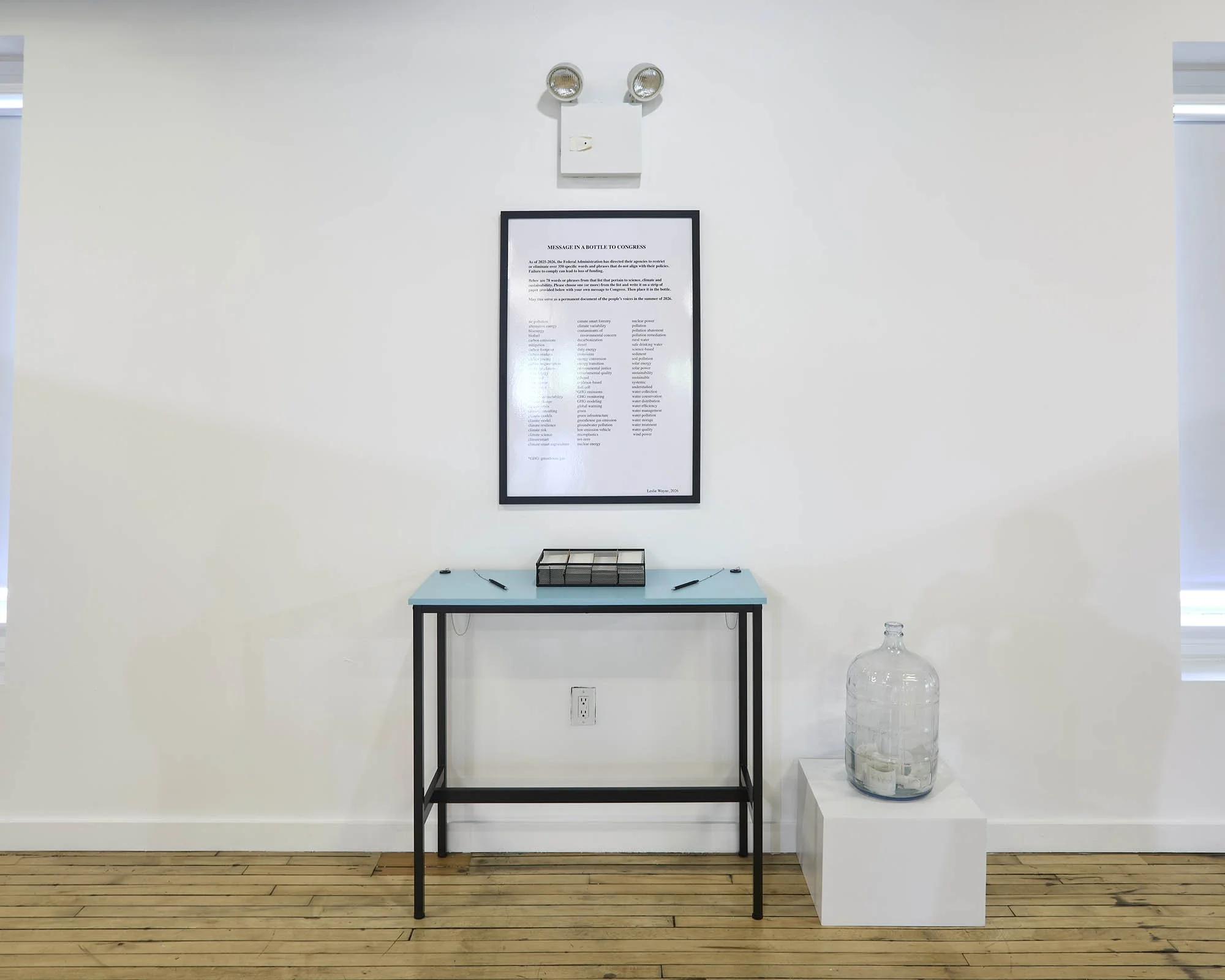 Message in a Bottle to Congress, 2026, glass bottle, poster, table, pens, paper, dimensions variable. Installation view, The Unintended Blues at LMCC Arts Center Governors Island, July 23 - September 27, 2026