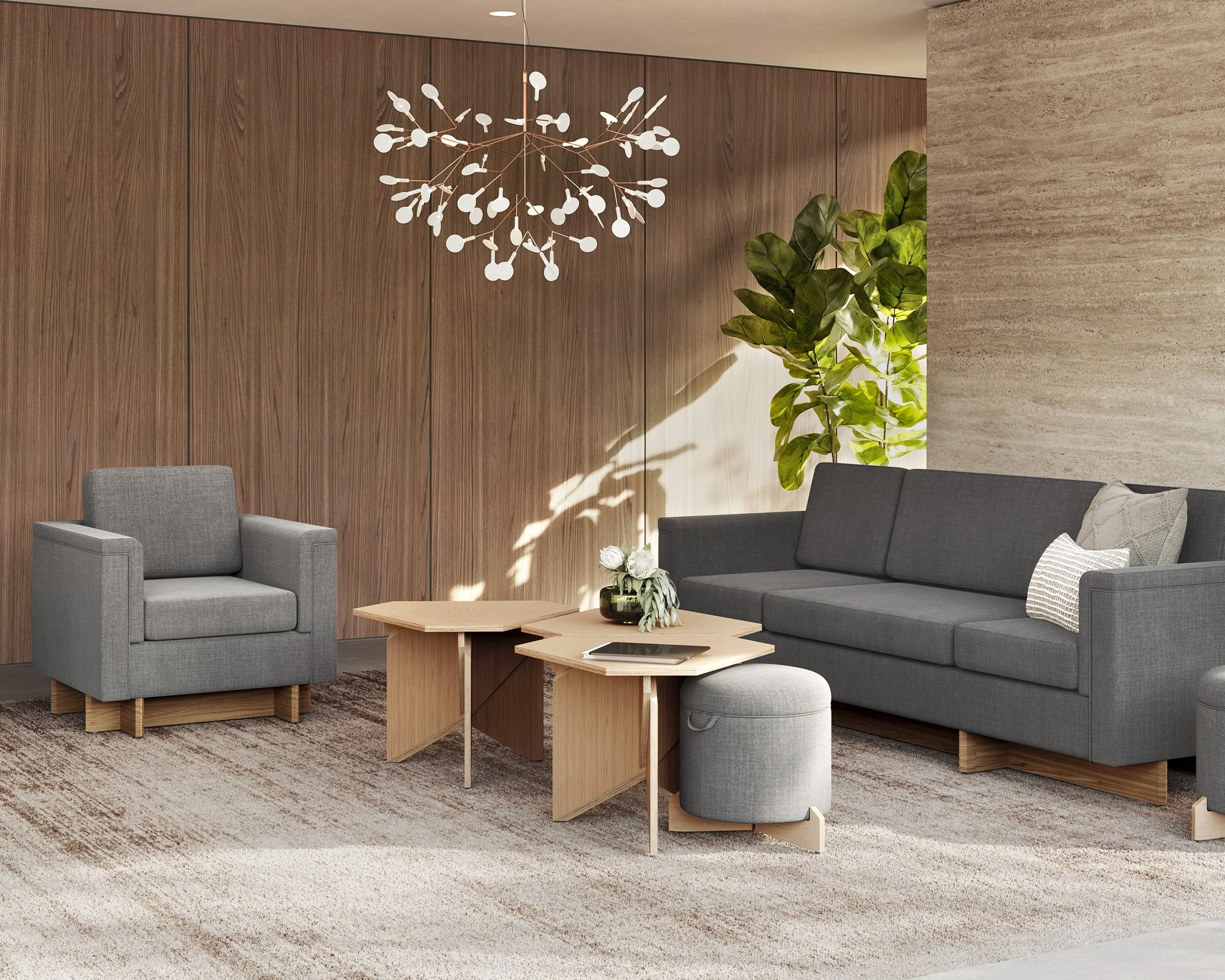 Modern lounge area with gray sofa and armchair and wooden coffee tables.