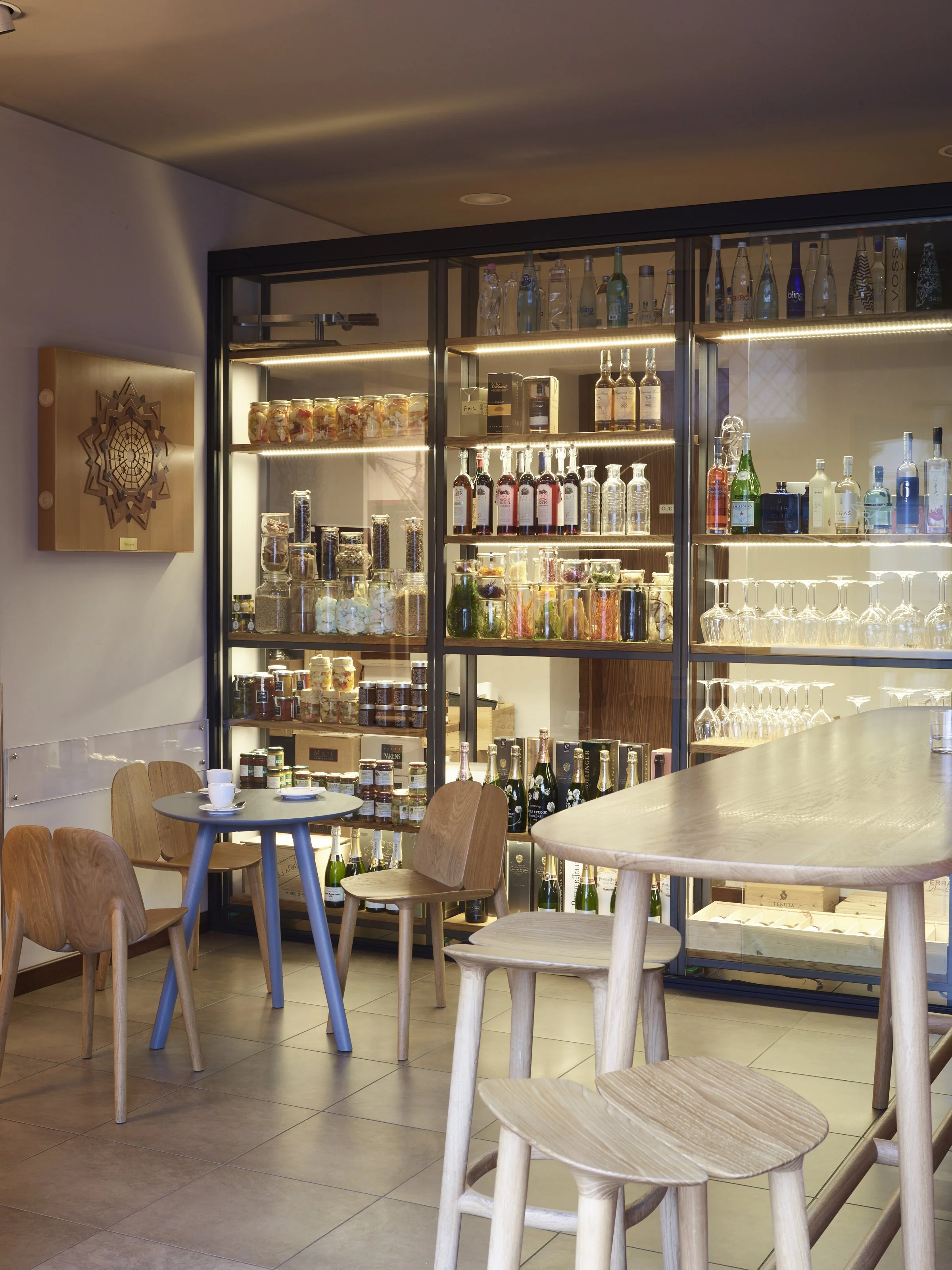 Cozy work café with wooden tables and chairs by Mattiazzi.