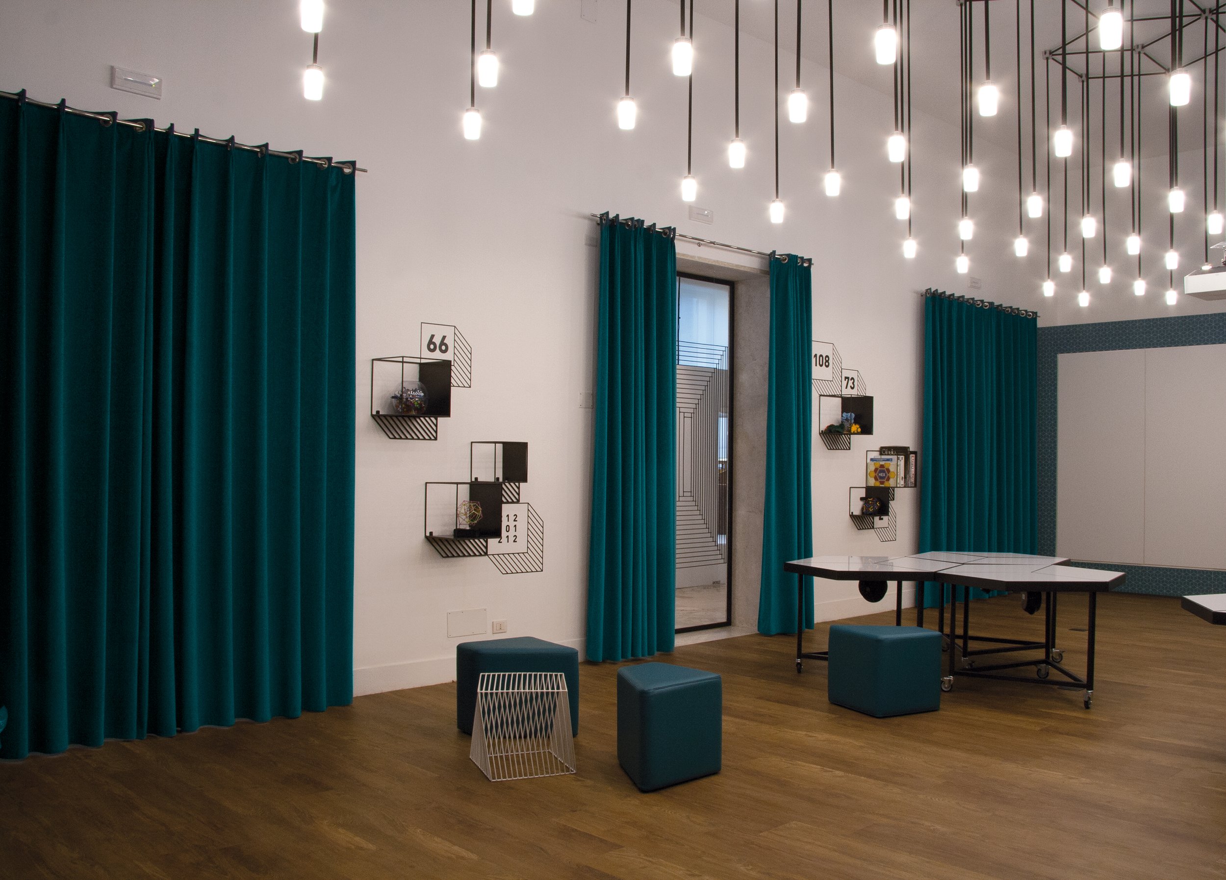 Modern indoor lounge area with teal acoustic curtains from Snowsound.