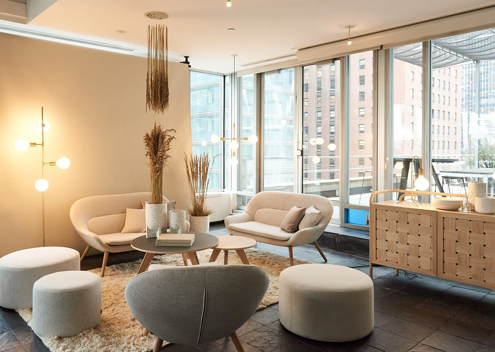 Modern lounge area with beige and gray Bolia furniture.