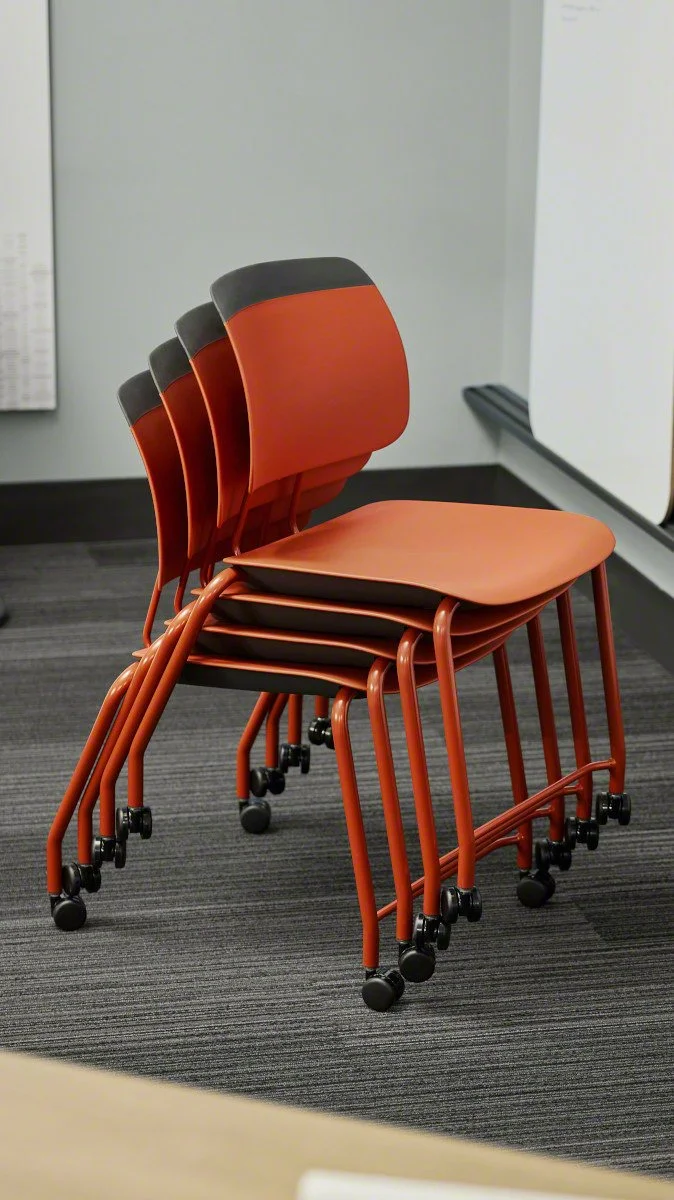 Stack of classroom chairs with wheels from Steelcase Learning, designed for small classrooms.