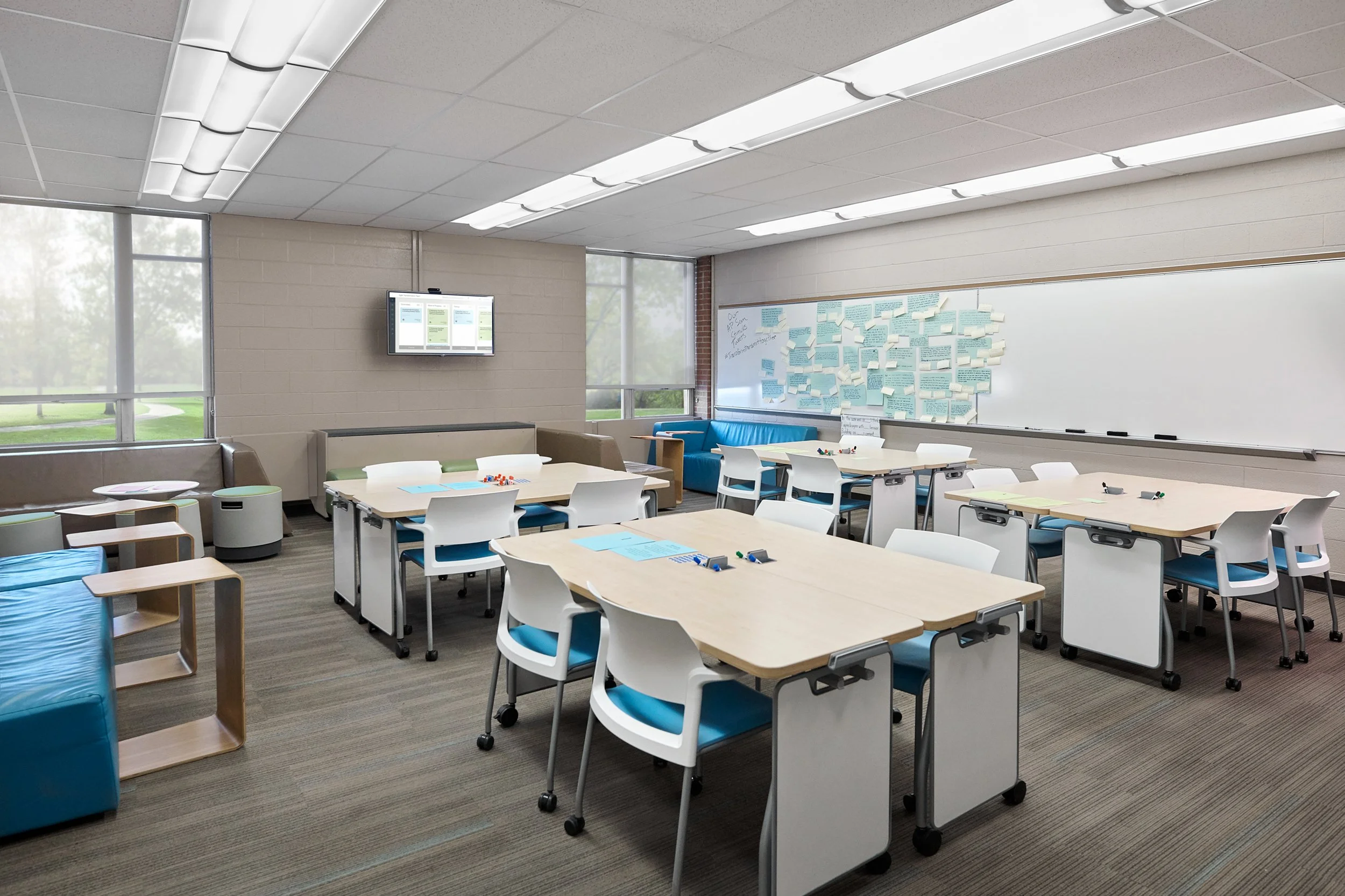 Classroom featuring multiple Steelcase Learning chairs and desk tables with hooks to hang individual whiteboards for student use.