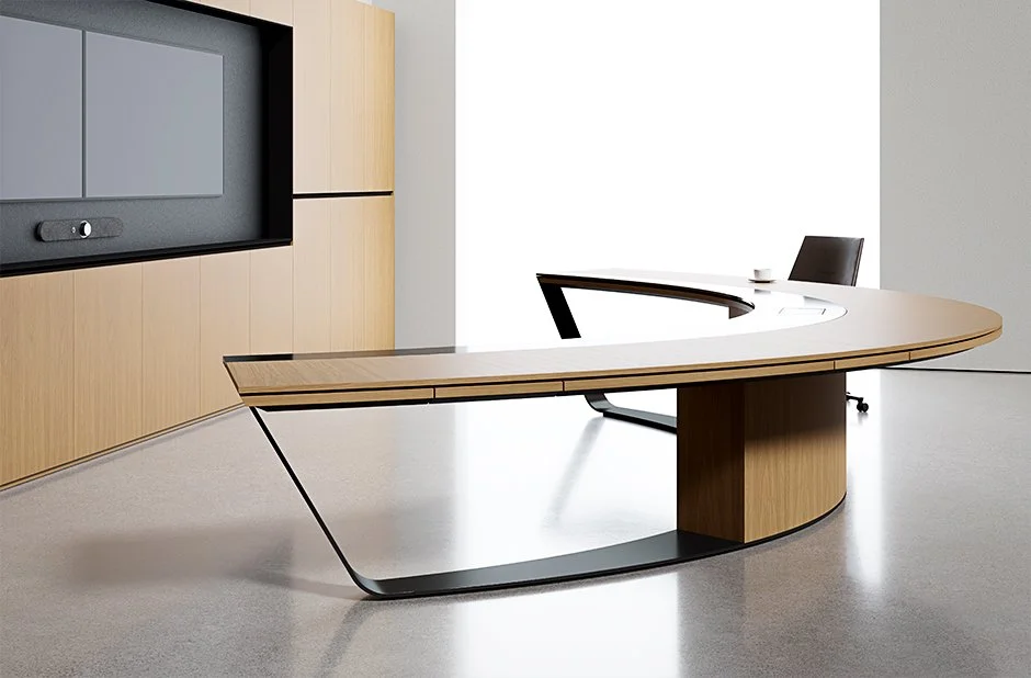 Modern wooden curved reception desk from Halcon with a wall system for AV display.