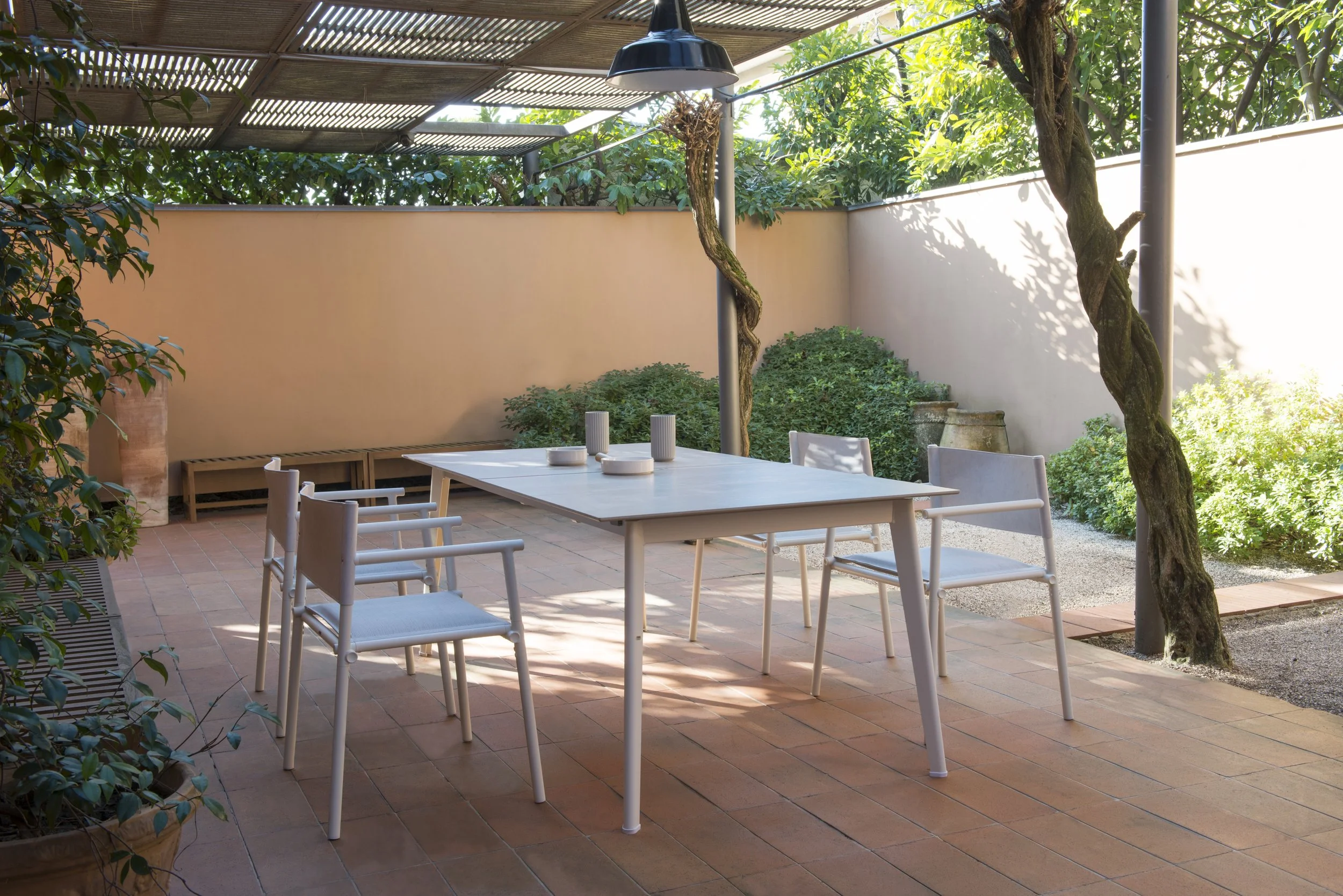 Outdoor patio with a white table and matching chairs from Emu outdoor furniture.