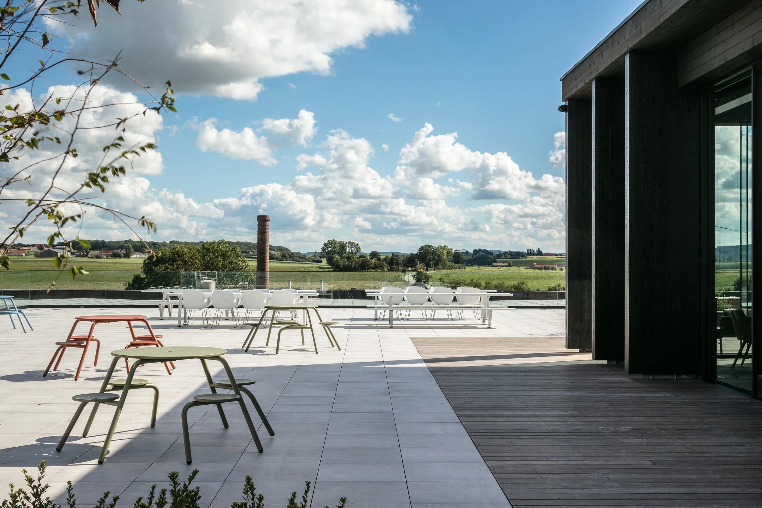 Outdoor terrace featuring colorful tables and chairs from outdoor furniture manufacturer Extremis.
