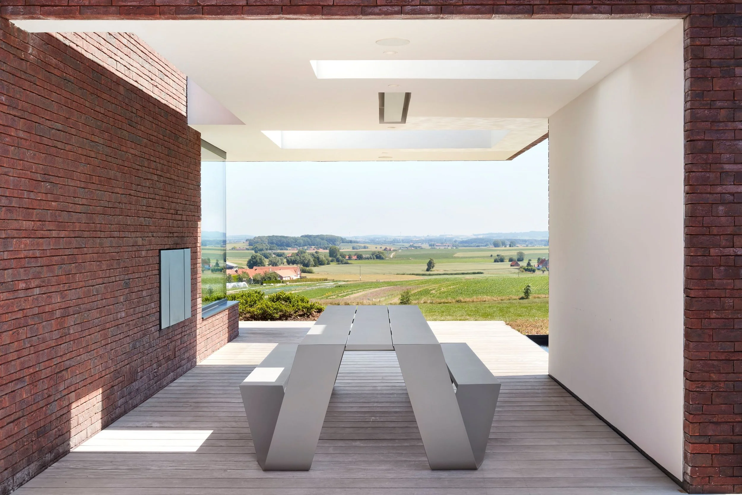 Outdoor area at a university featuring white benches from Extremis outdoor furniture.