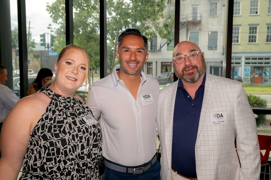 Katy Lovell, Francisco Morales, and Paul Maczka from Workplace Solutions at a corporate event, smiling for a photo.