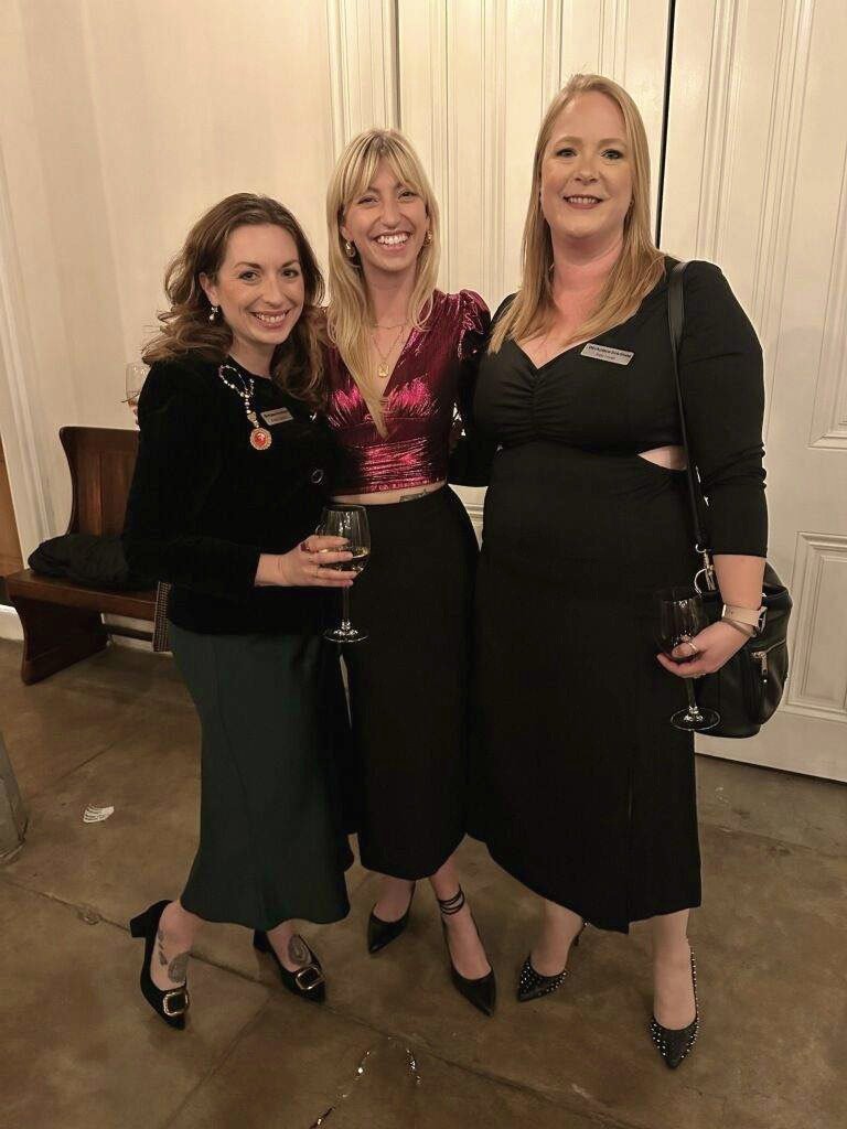 Brittany Salerian, Kourtney Russo, and Katy Lovell posing for a picture at the 2024 Holiday Party hosted by the American Institute of Architects New Orleans, IIDA, the National Association of Women in Construction, and the Urban Land Institute (ULI).