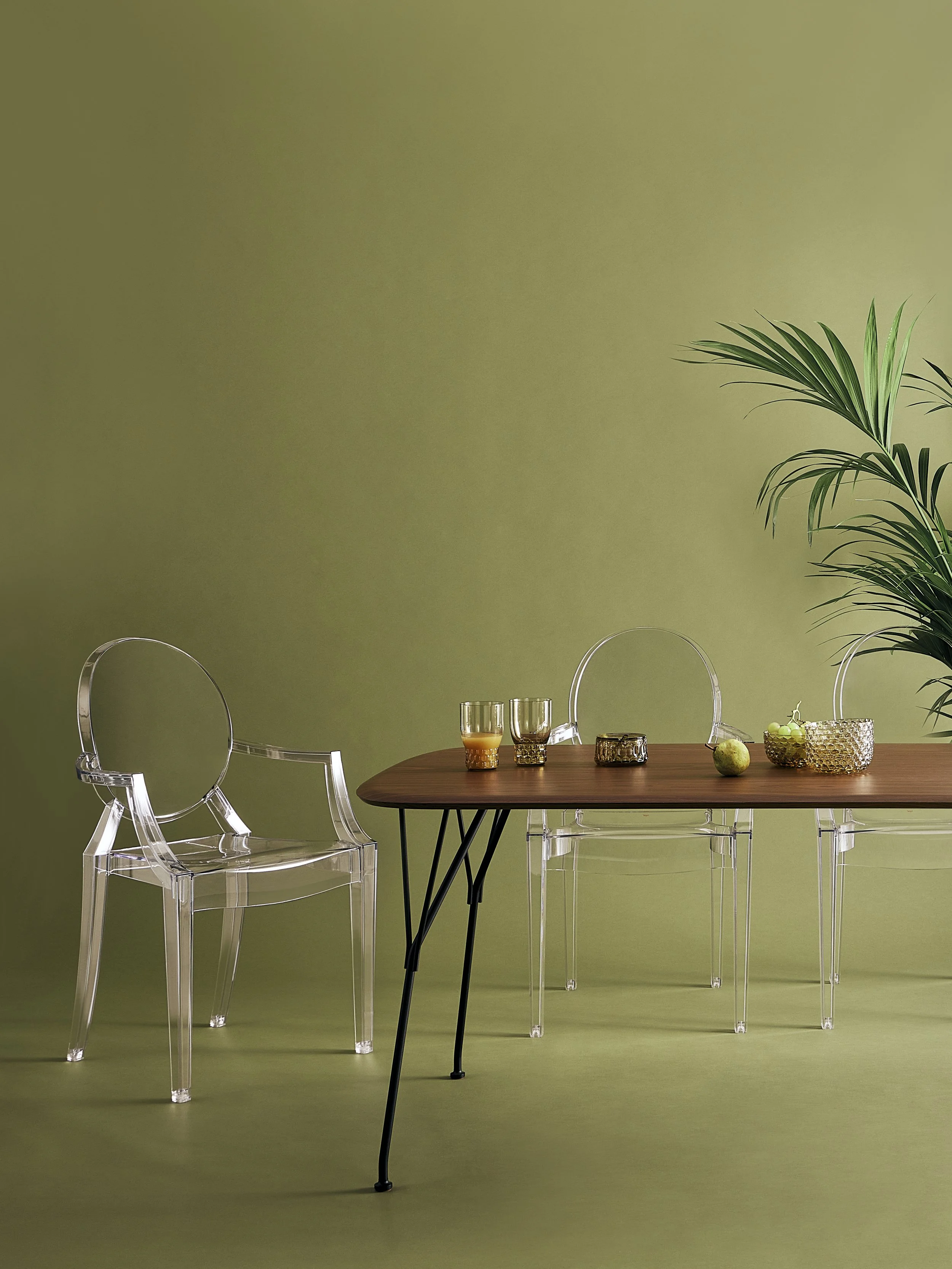 Modern dining area with a wooden table and transparent chairs from Kartell.