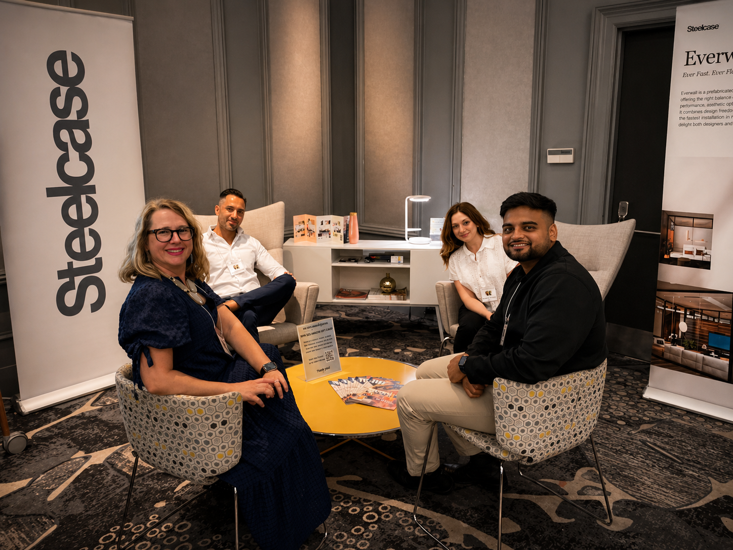 The Workplace Solutions and Steelcase team seated together at the Association of Legal Administrators (ALA) Partners Tradeshow, smiling for a group photo.