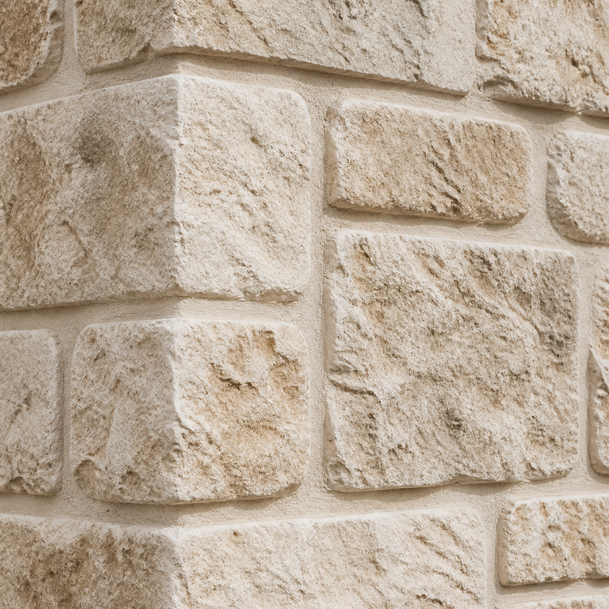 Close-up of large-format Rough Cut Stone veneer with textured surfaces and carefully finished mortar joints