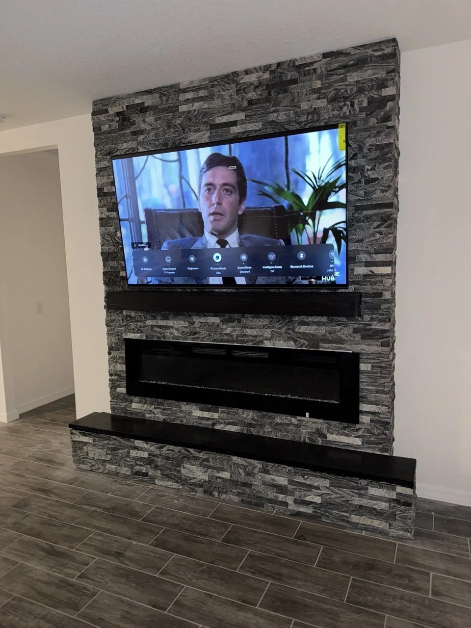 Palm Bay_media wall stone with fireplace.jpeg