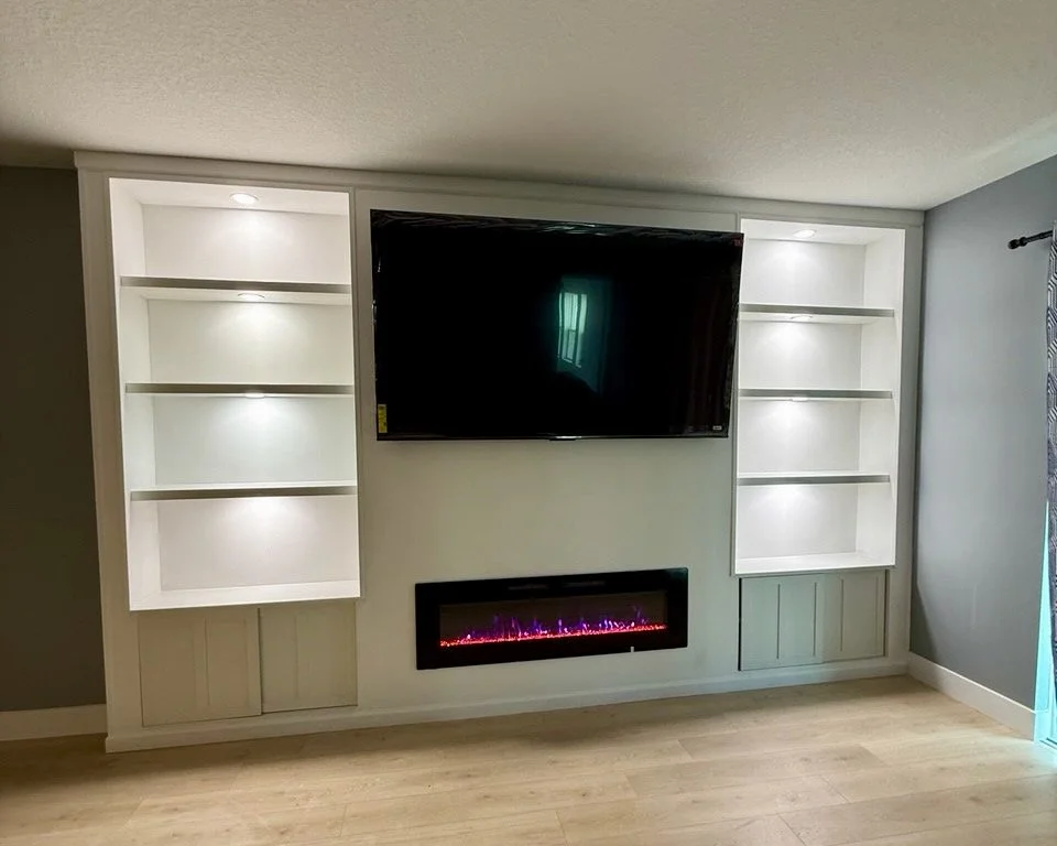 Limewash built-in entertainment center with TV and electric fireplace in Bradenton Florida
