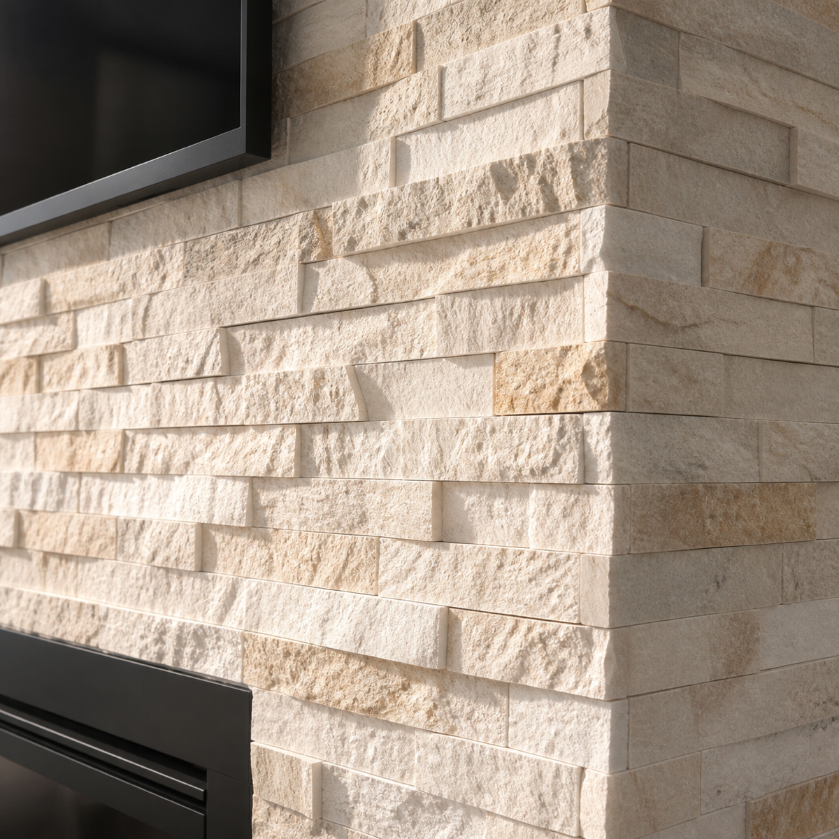 Close-up of professionally installed light ledger stone veneer with layered texture and a finished corner