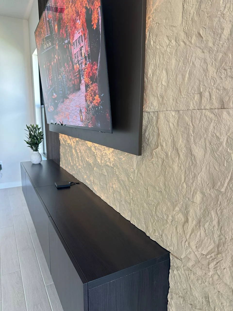 Floating TV frame detail on custom media wall installation