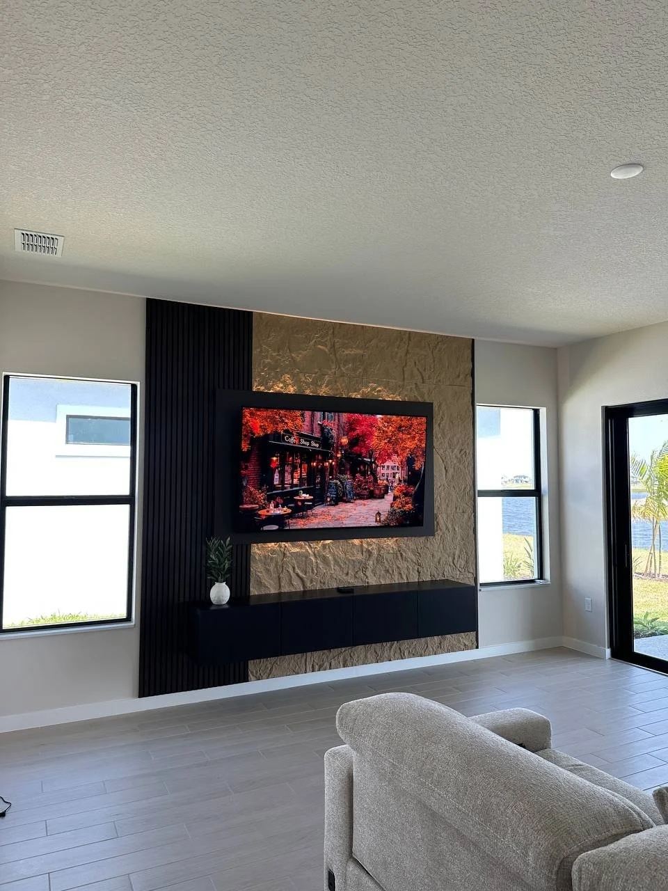 Modern entertainment center with floating cabinet and TV wall in Orlando Florida