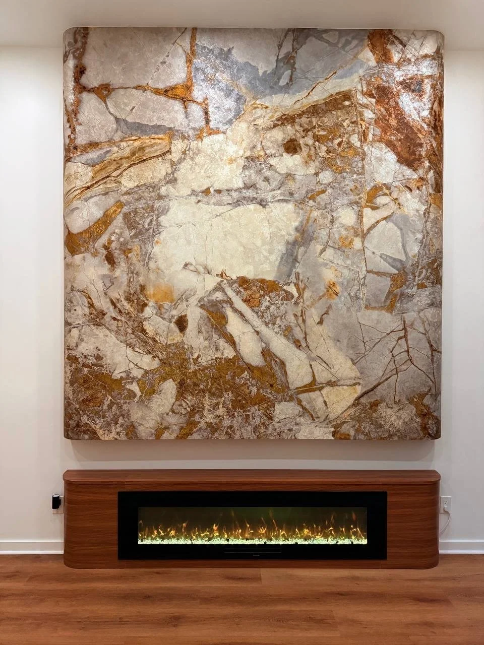 Marble-look decorative feature wall with custom floating fireplace base in a contemporary Houston living room