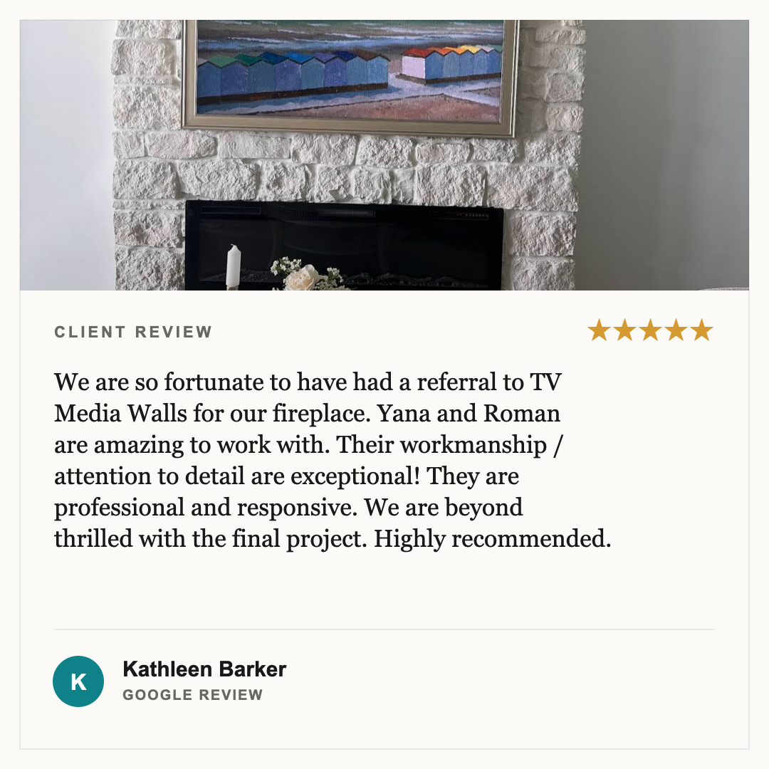 A cozy living room fireplace with a white brick surround, decorated with a candle and flowers. Above it hangs a framed painting of colorful beach huts.