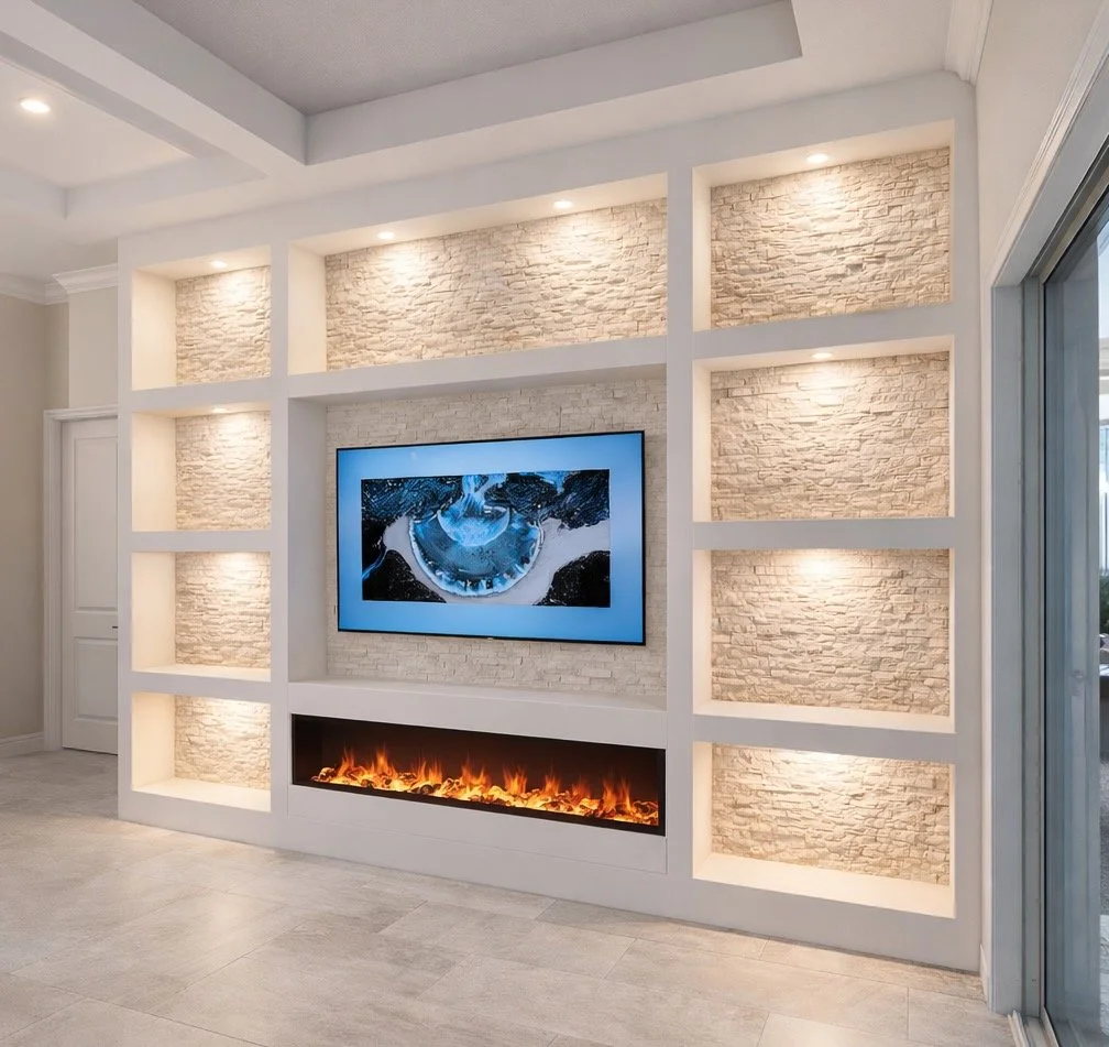 Living room wall with built-in fireplace, mounted flat-screen TV displaying an image, and illuminated niches with textured stone backing.