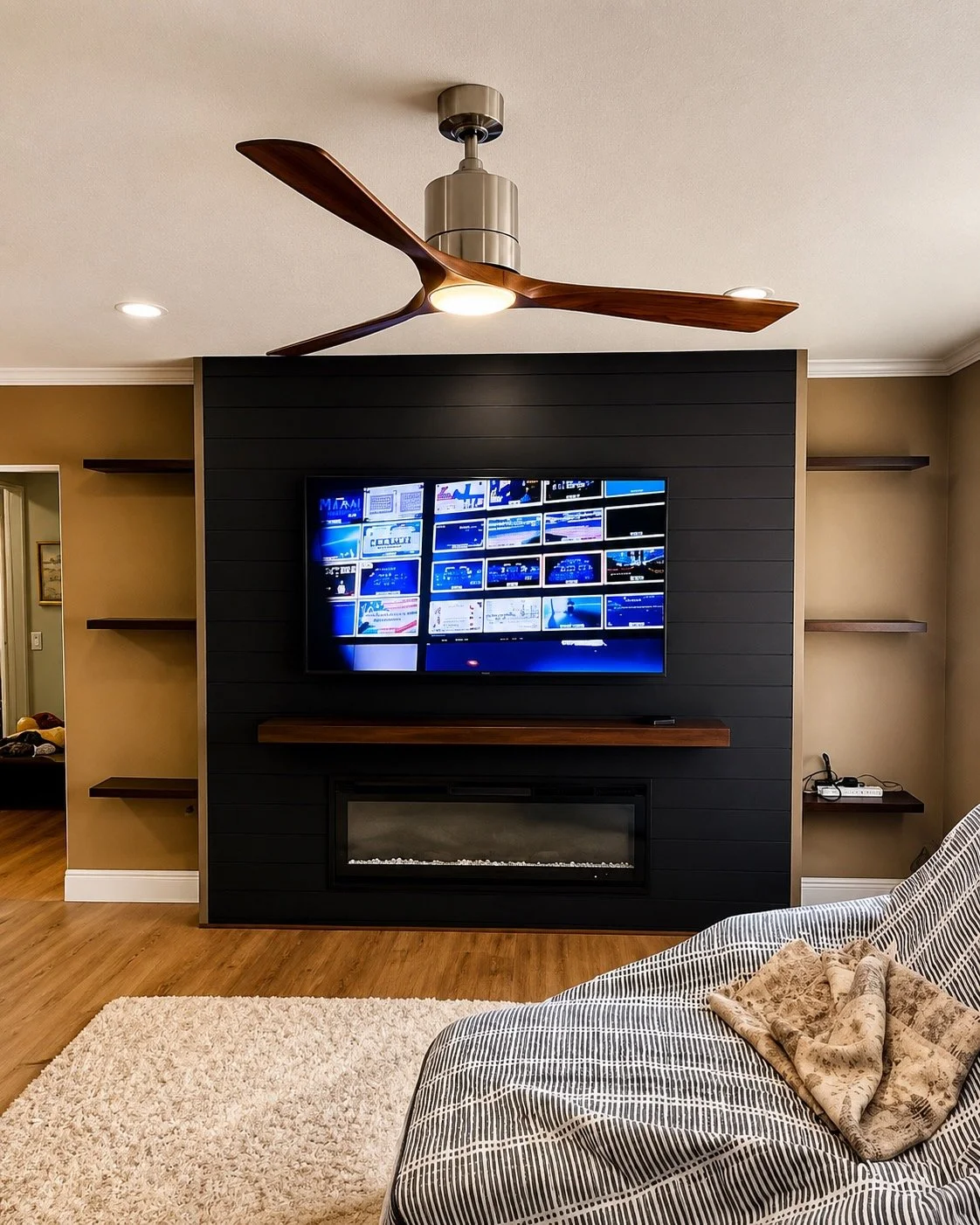 Custom black TV fireplace wall with floating wood shelves in Sarasota FL