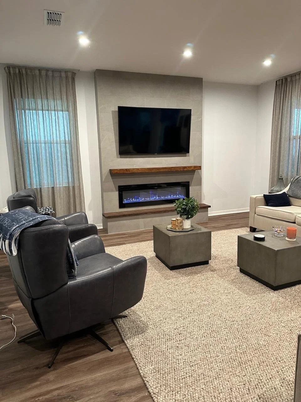 wide living room view with fireplace media wall and seating area