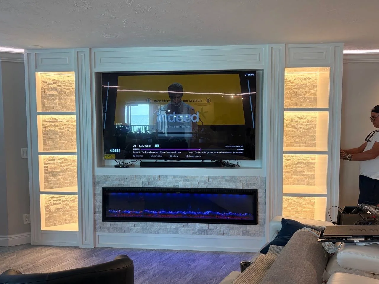 White Stone Fireplace Media Wall with Illuminated Display Niches – Clearwater Beach, Florida