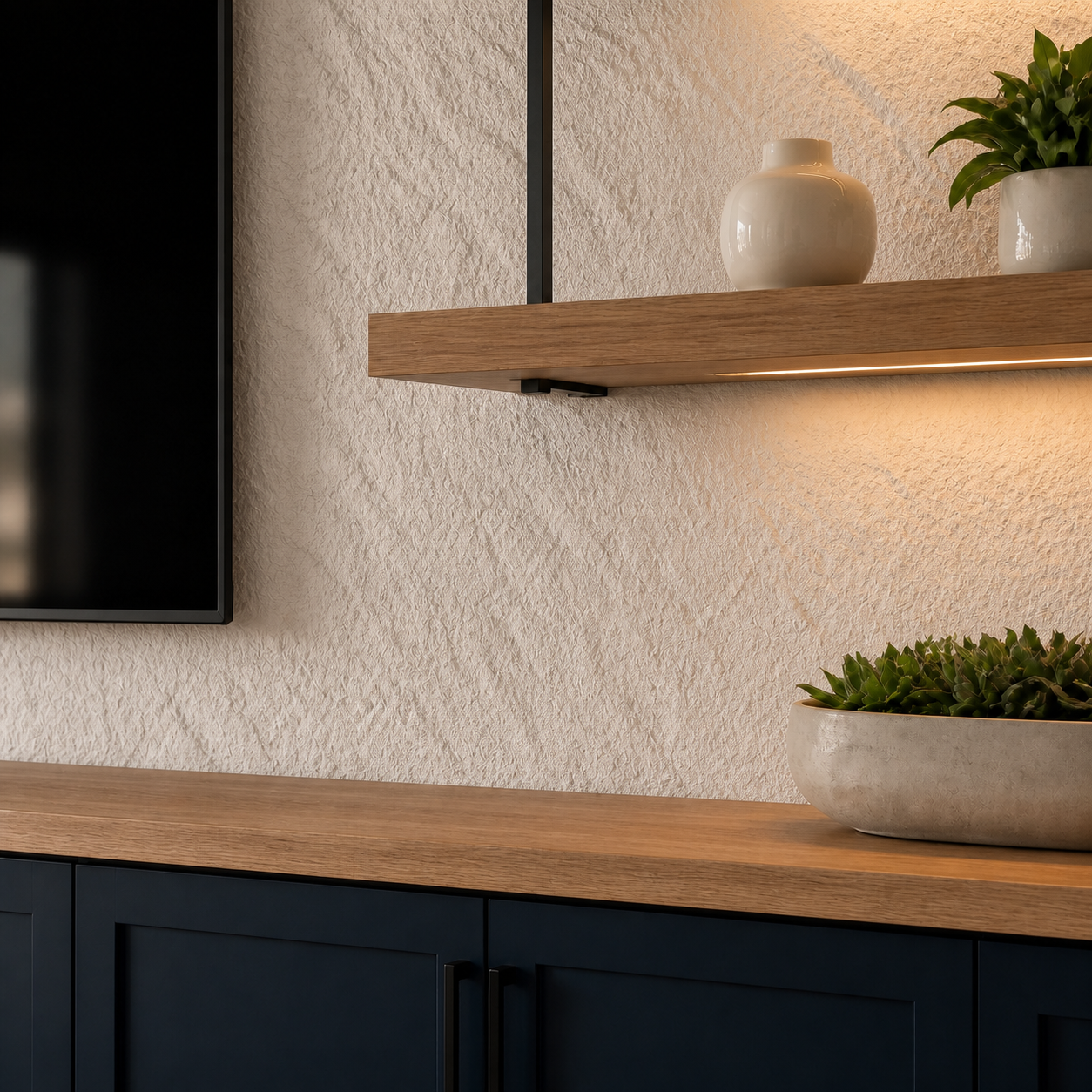 Light stone-look wall panels paired with oak shelving and navy storage cabinets
