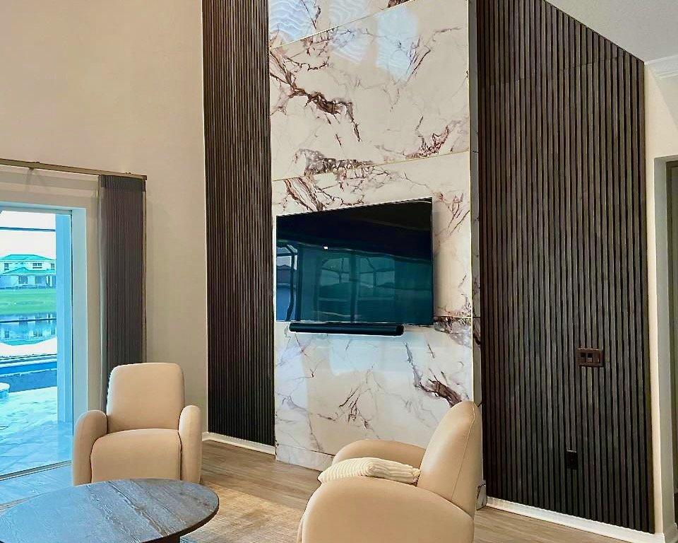Angle view of marble slab TV wall with vertical slats in Orlando home
